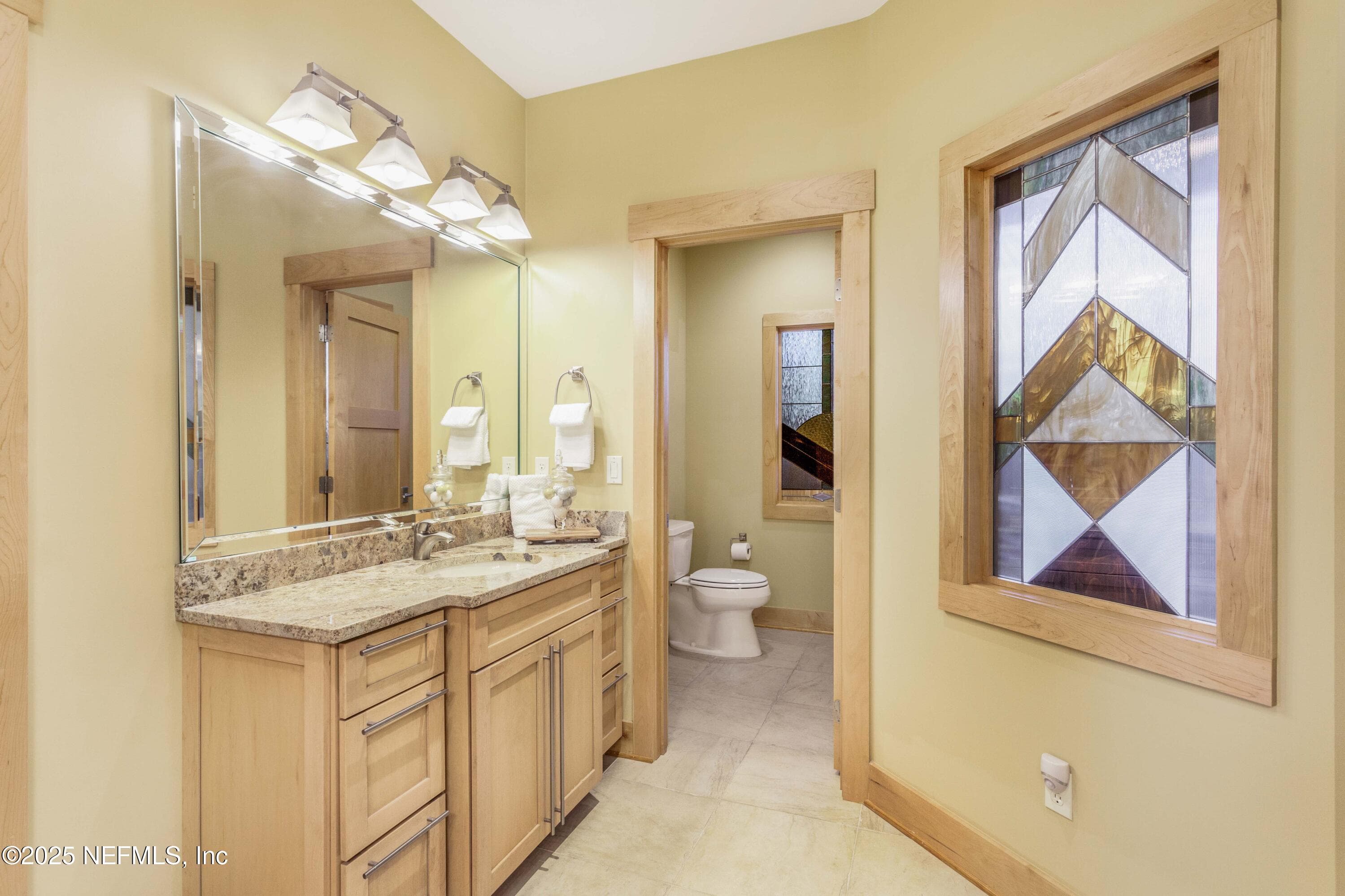 Dual vanities in primary, stained glass accent. — 940564 OLD NASSAUVILLE Road, Fernandina Beach, FL 32034