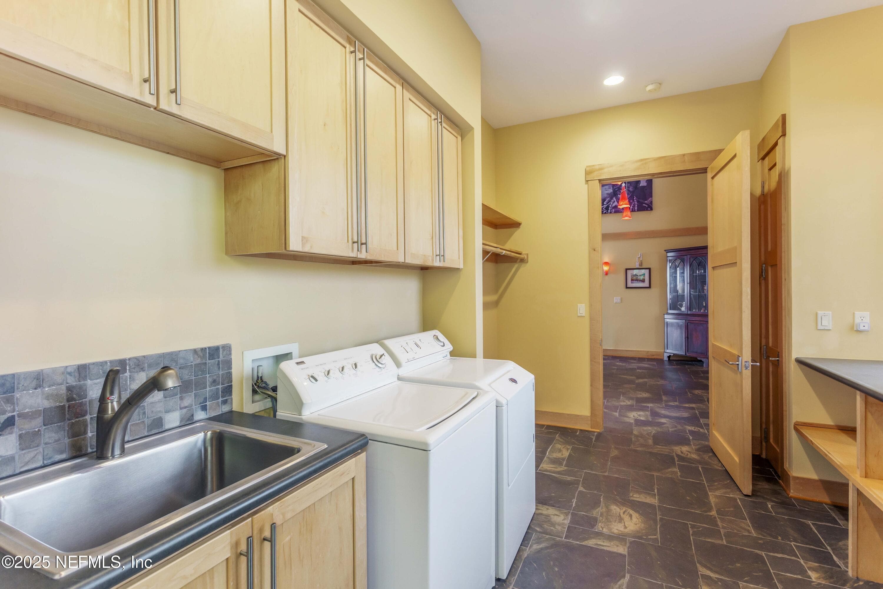 Laundry with utility sink, folding table, and closets. — 940564 OLD NASSAUVILLE Road, Fernandina Beach, FL 32034