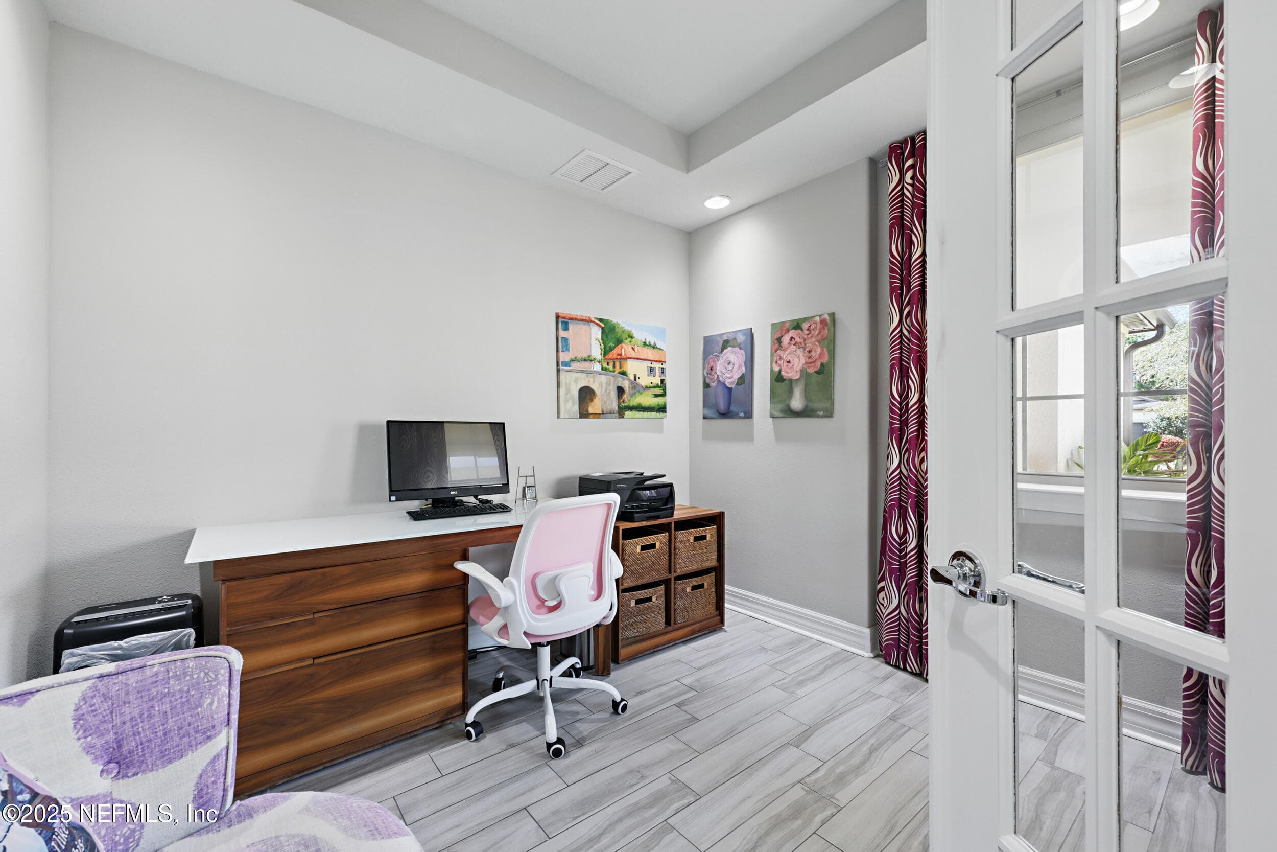 Den/office — First-floor den with French door entry, wood-look tile flooring, recessed lighting, and large window with natural light. Room functions as a home office or flex space. — 92 CANOPY OAK Lane, Ponte Vedra, FL 32081