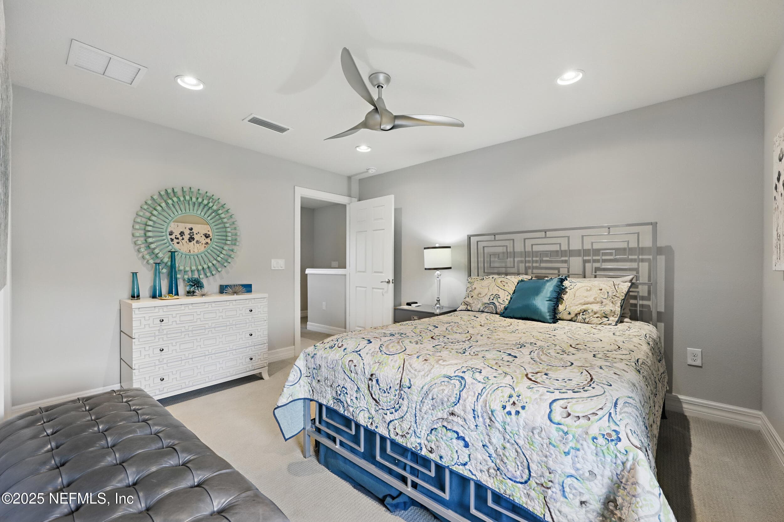 Third bedroom (alternate angle) — Second-floor bedroom with carpet flooring, modern ceiling fan, recessed lighting, closet, and staircase access to the main level. Room accommodates a full-size bed with space for additional furniture. — 92 CANOPY OAK Lane, Ponte Vedra, FL 32081