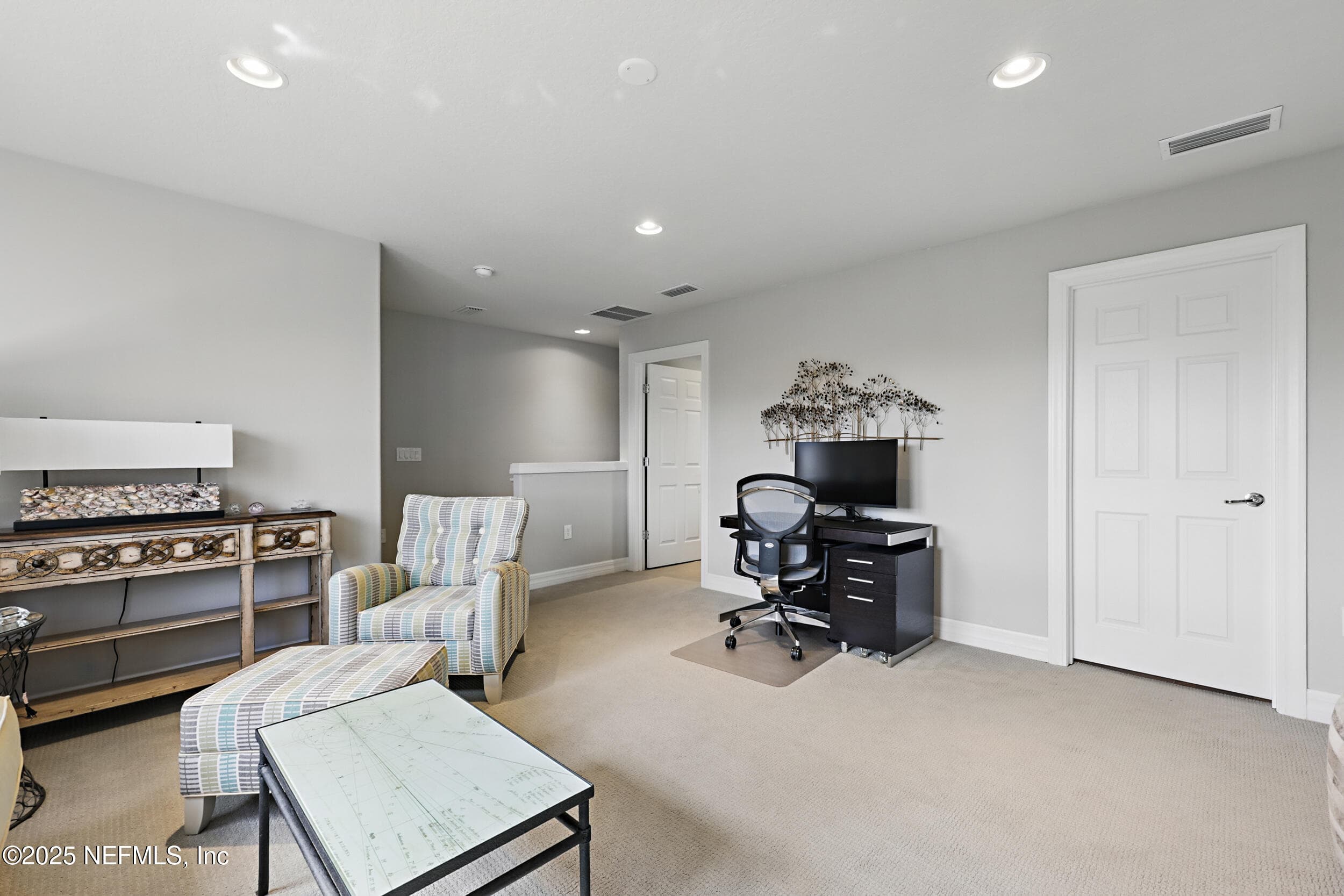 Second-floor loft (staircase and office area) — Loft area at the top of the carpeted staircase with recessed lighting, desk workspace, closet storage, and open layout connecting to the third bedroom. — 92 CANOPY OAK Lane, Ponte Vedra, FL 32081