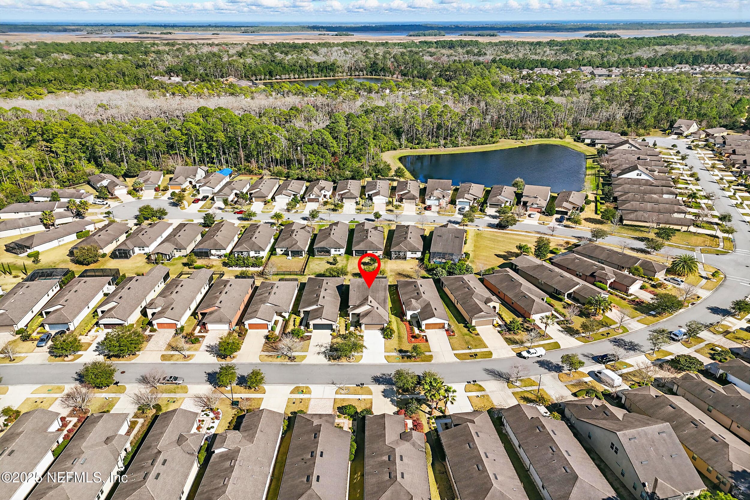 Aerial (community wide) — Wide aerial view of Del Webb Ponte Vedra showing the home's location within the community, community pond, preserve tree canopy, and surrounding neighborhood layout. Located in Ponte Vedra, FL 32081. — 92 CANOPY OAK Lane, Ponte Vedra, FL 32081