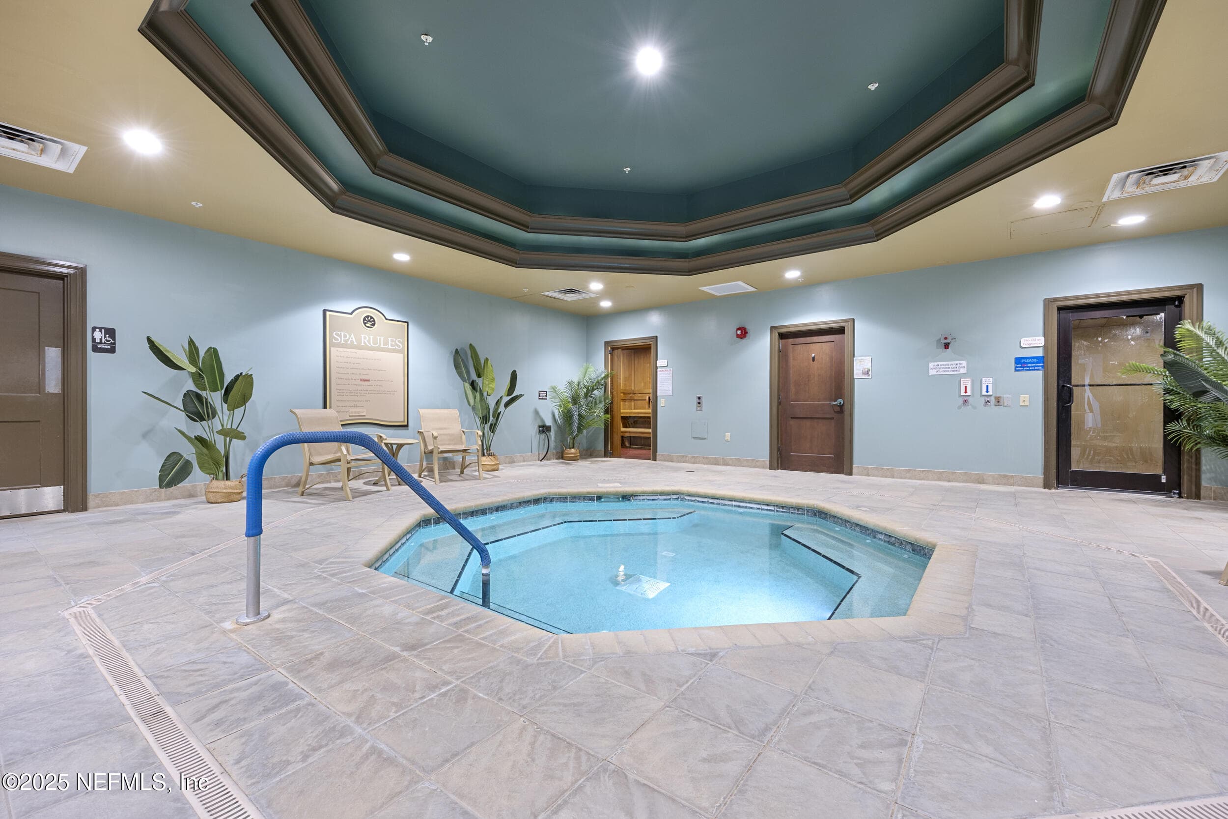 Anastasia Clubhouse indoor spa — Indoor spa room inside the Anastasia Clubhouse with heated whirlpool spa, tile surround, octagonal tray ceiling, lounge seating, sauna room entry, and steam room access. Part of the wellness amenities at Del Webb Ponte Vedra. — 92 CANOPY OAK Lane, Ponte Vedra, FL 32081