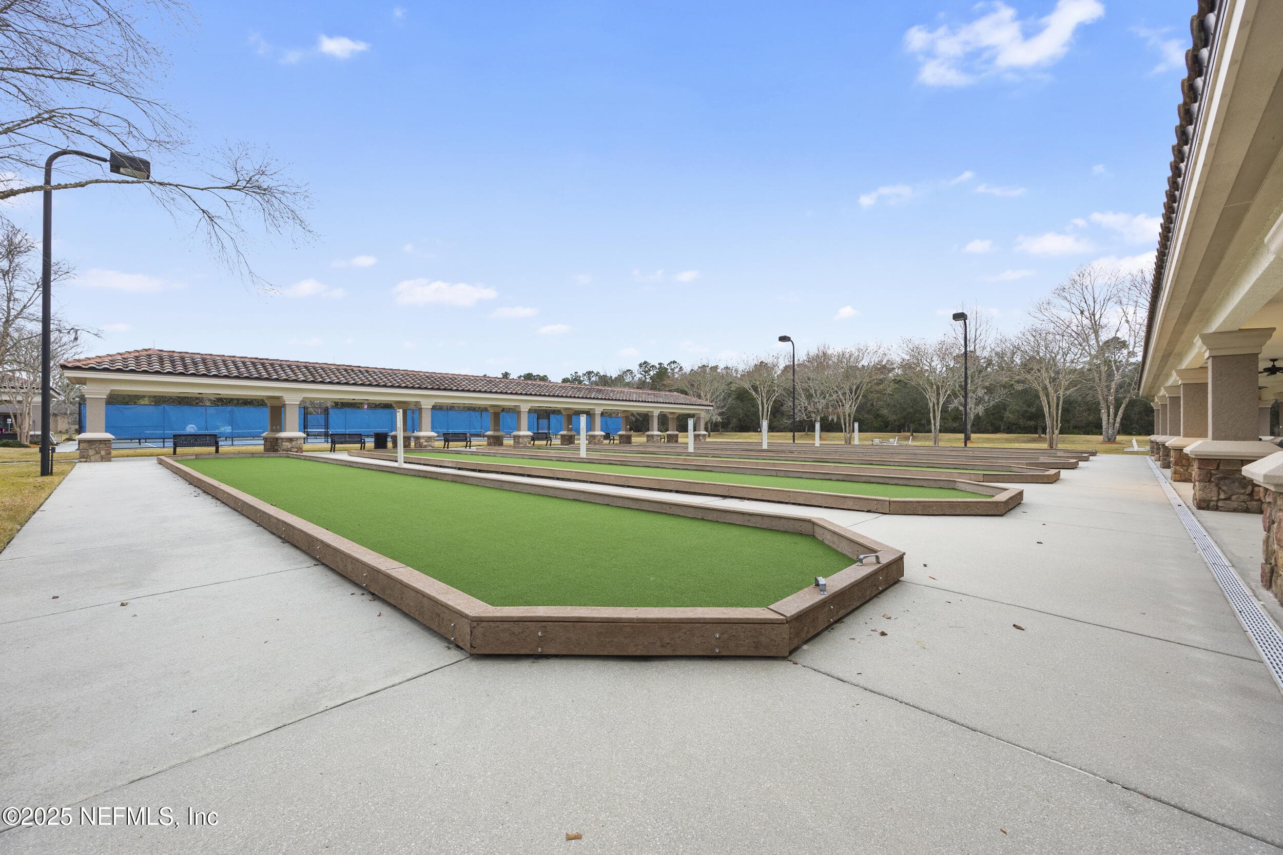 Del Webb Ponte Vedra bocce ball courts — Lighted bocce ball courts with artificial turf playing surfaces, covered spectator pavilion with bench seating, and adjacent pickleball courts at the Anastasia Clubhouse in Del Webb Ponte Vedra. — 92 CANOPY OAK Lane, Ponte Vedra, FL 32081