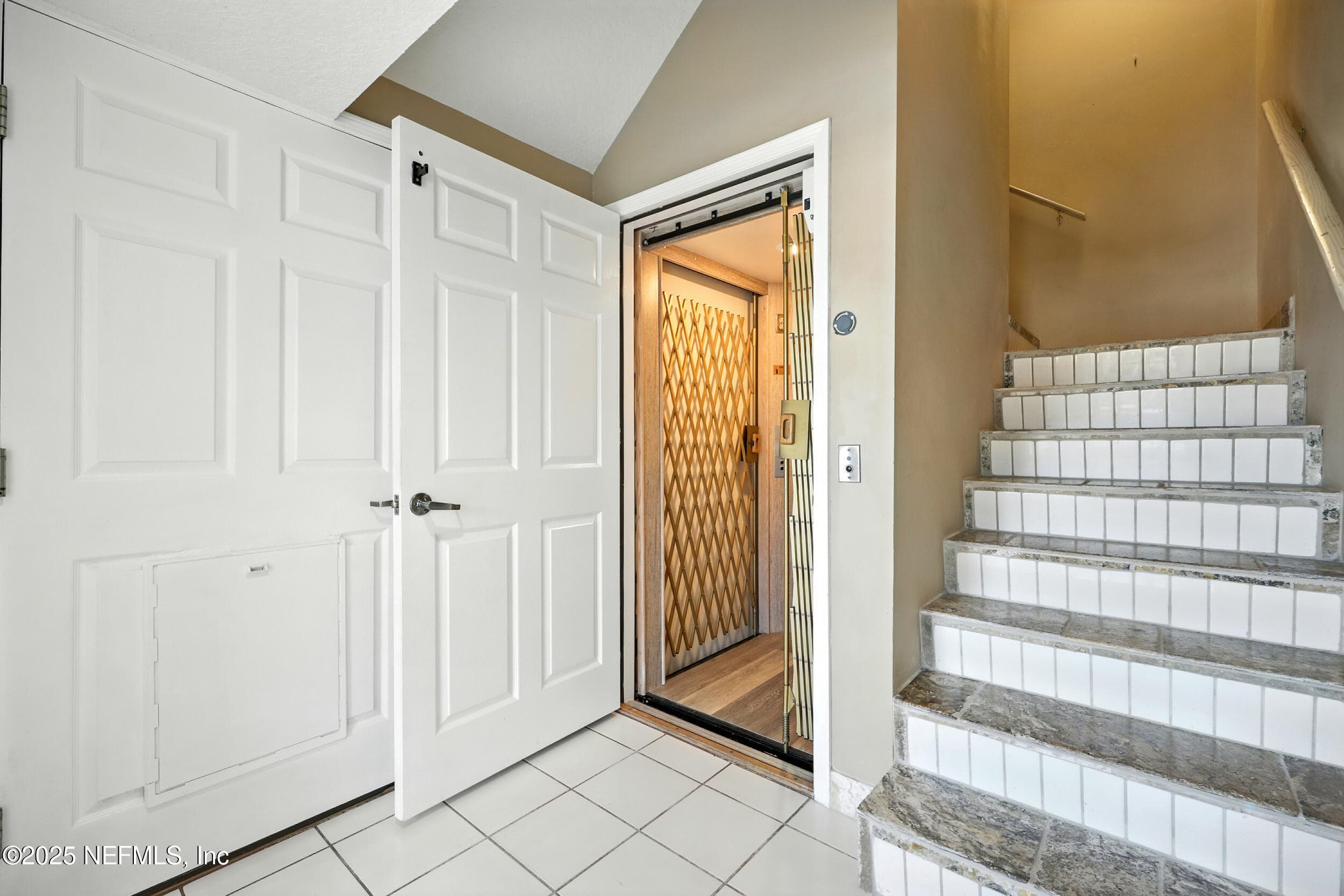 Stairway leading to upper floors with elevator right next to the stairs — 3331 LIGHTHOUSE POINT Lane, Jacksonville, FL 32250
