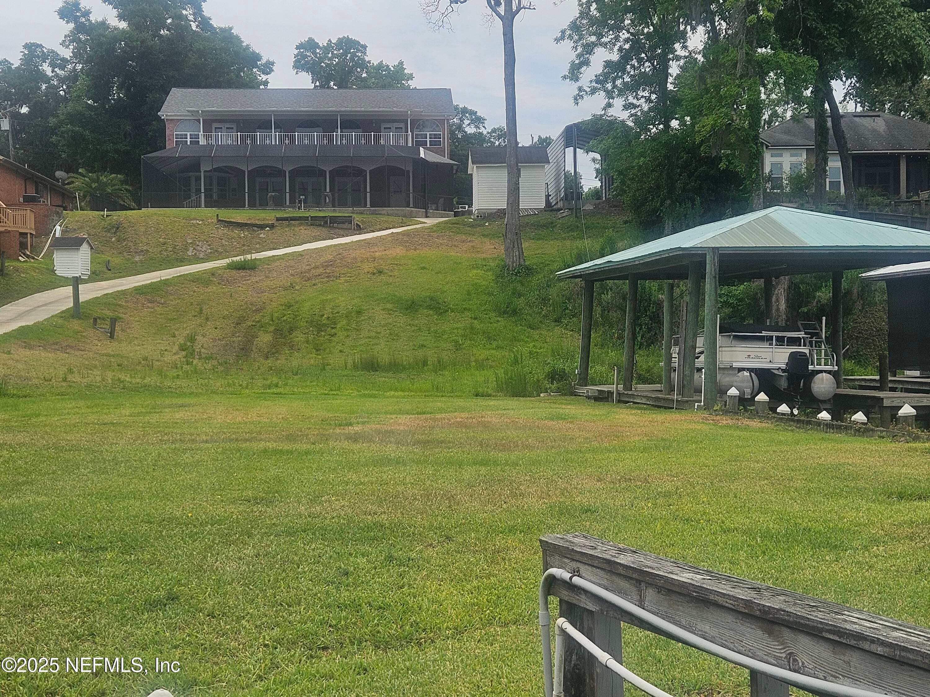 View back of house from Black Creek from Gazabo. Boathouse to the right — 435 LAKE ASBURY Drive, Green Cove Springs, FL 32043
