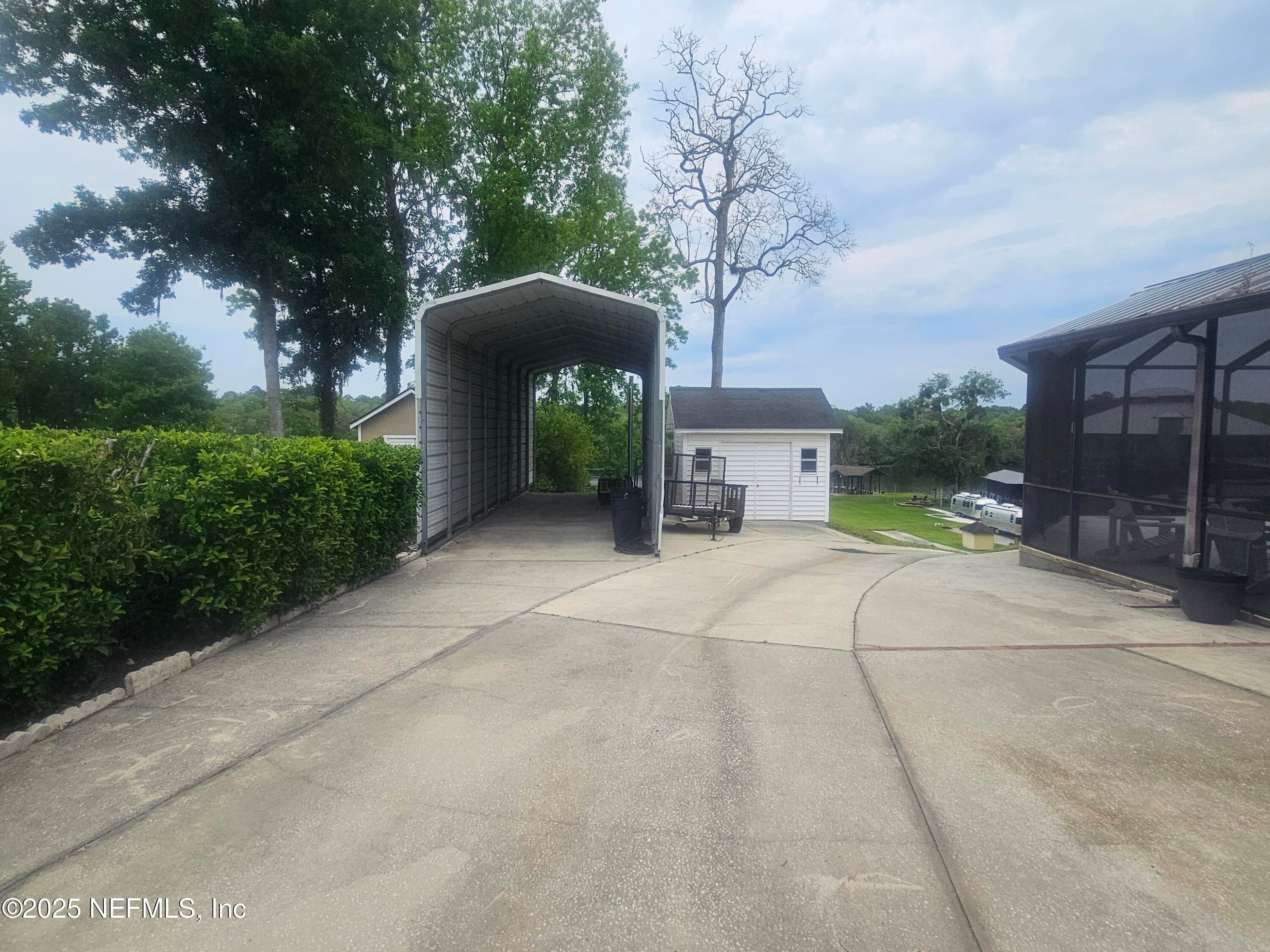 Driveway view of Covered Boat RV covered storage and Driveway down hill to Black Creek — 435 LAKE ASBURY Drive, Green Cove Springs, FL 32043