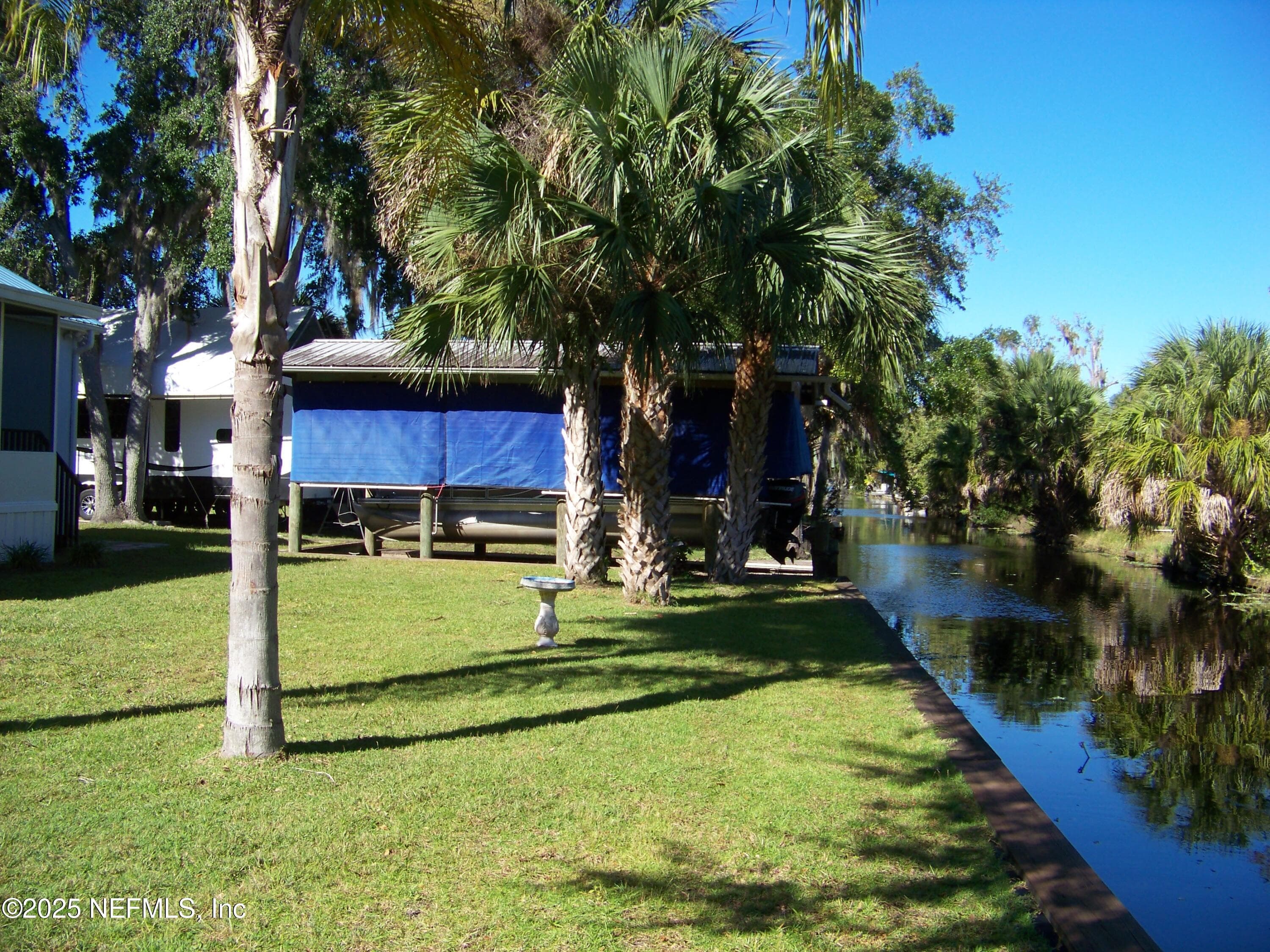 Backyard view of bulkhead and boathouse — 118 HICKS Avenue, Crescent City, FL 32112