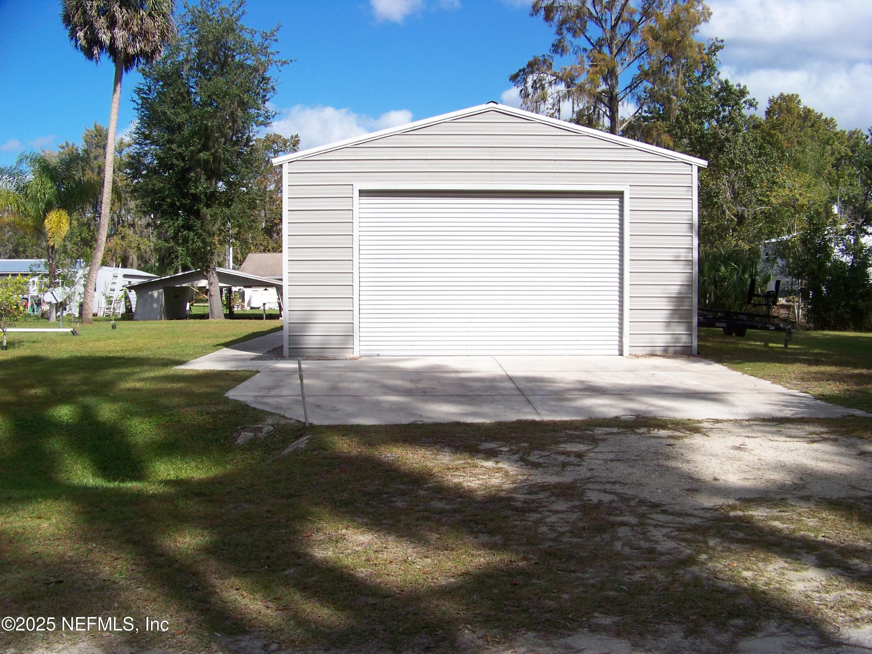 10' garage door with concrete parking pad — 118 HICKS Avenue, Crescent City, FL 32112