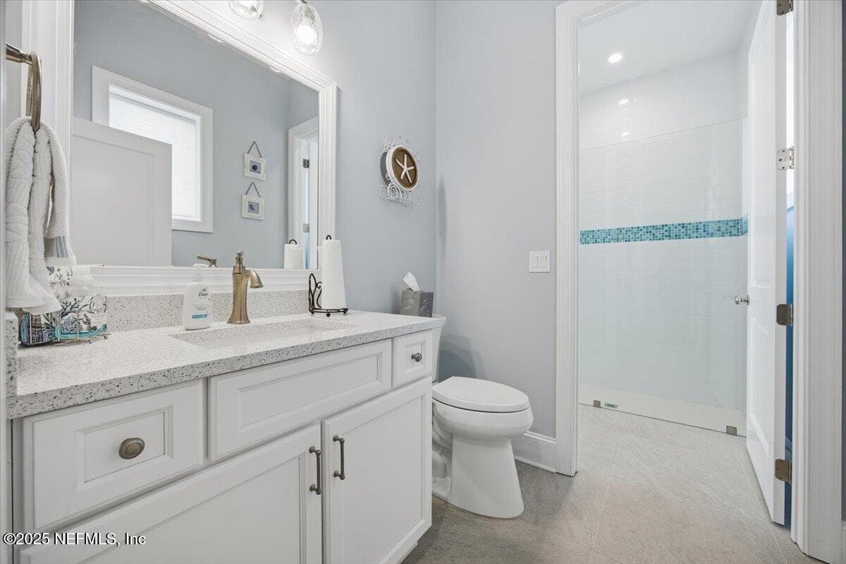 Front of house has bathroom with tall shower (beautiful trim tile from Design Works.) — 4 SUMMER Court, Jacksonville Beach, FL 32250