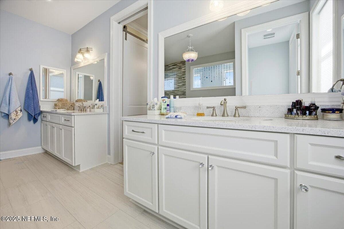 Two tall vanities, both have medicine cabinets. There is a pocket door to save space! — 4 SUMMER Court, Jacksonville Beach, FL 32250
