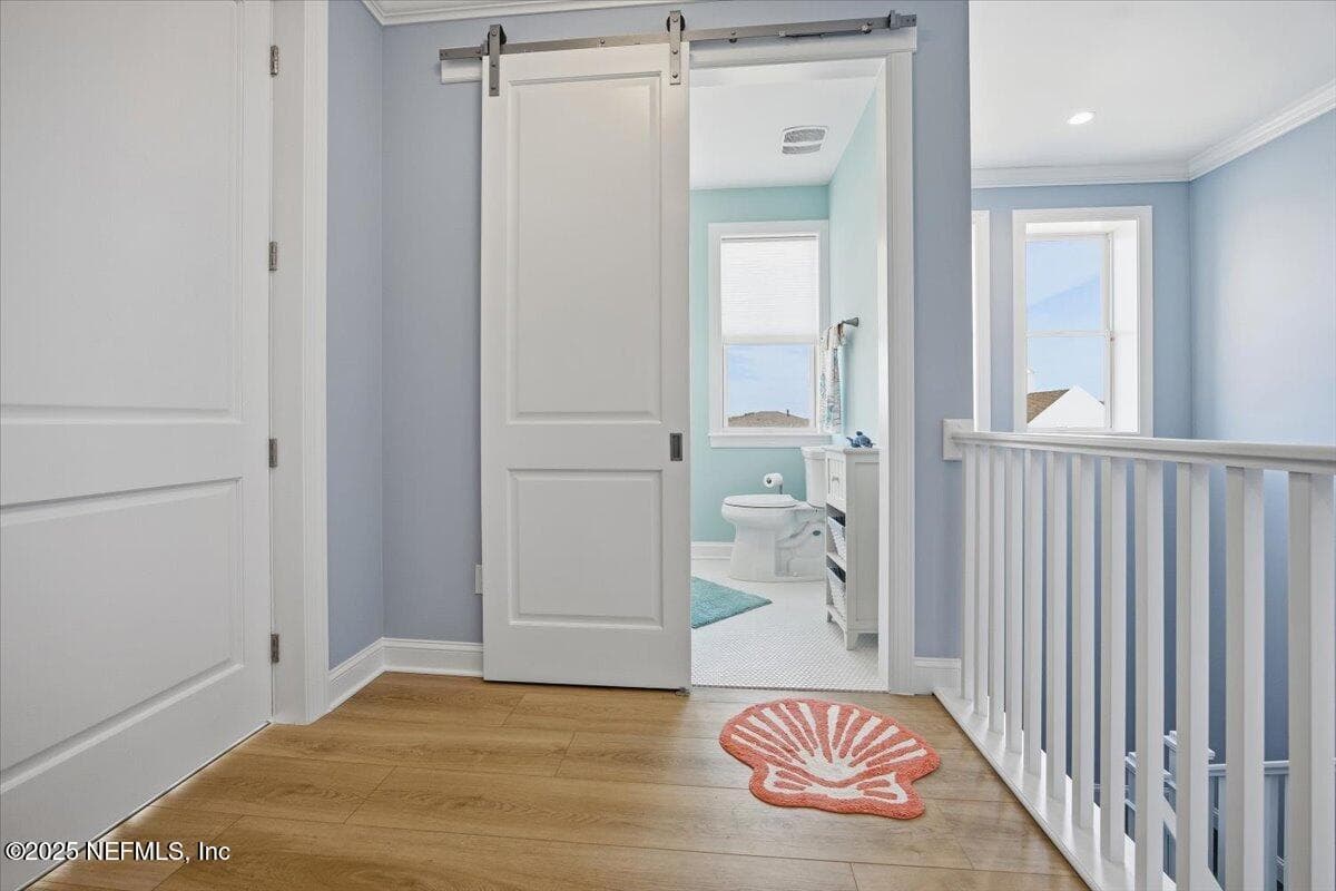 That's elevator to the left, cute beachy bathroom with barn door straight on, and lots of light from windows. Front stair are to the right. — 4 SUMMER Court, Jacksonville Beach, FL 32250