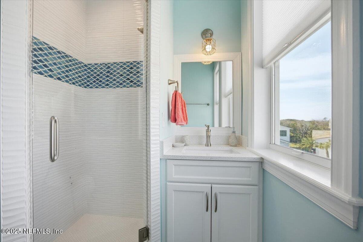 3rd floor guest suite bathroom - lovely tile looks like ocean waves. Two big windows provide nice light. — 4 SUMMER Court, Jacksonville Beach, FL 32250