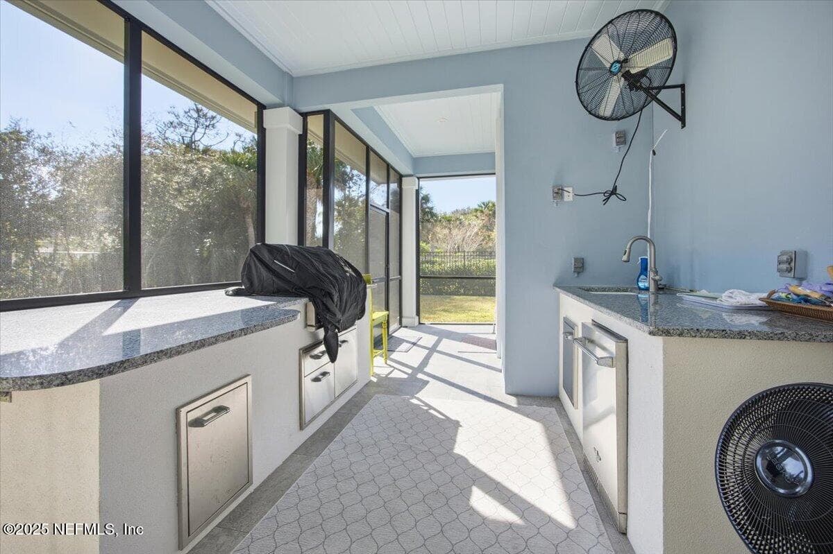Like to grill? A summer kitchen with two granite countertops, a Delta grill, refrigerator, sink and a HUGE fan to circulate the air out! — 4 SUMMER Court, Jacksonville Beach, FL 32250