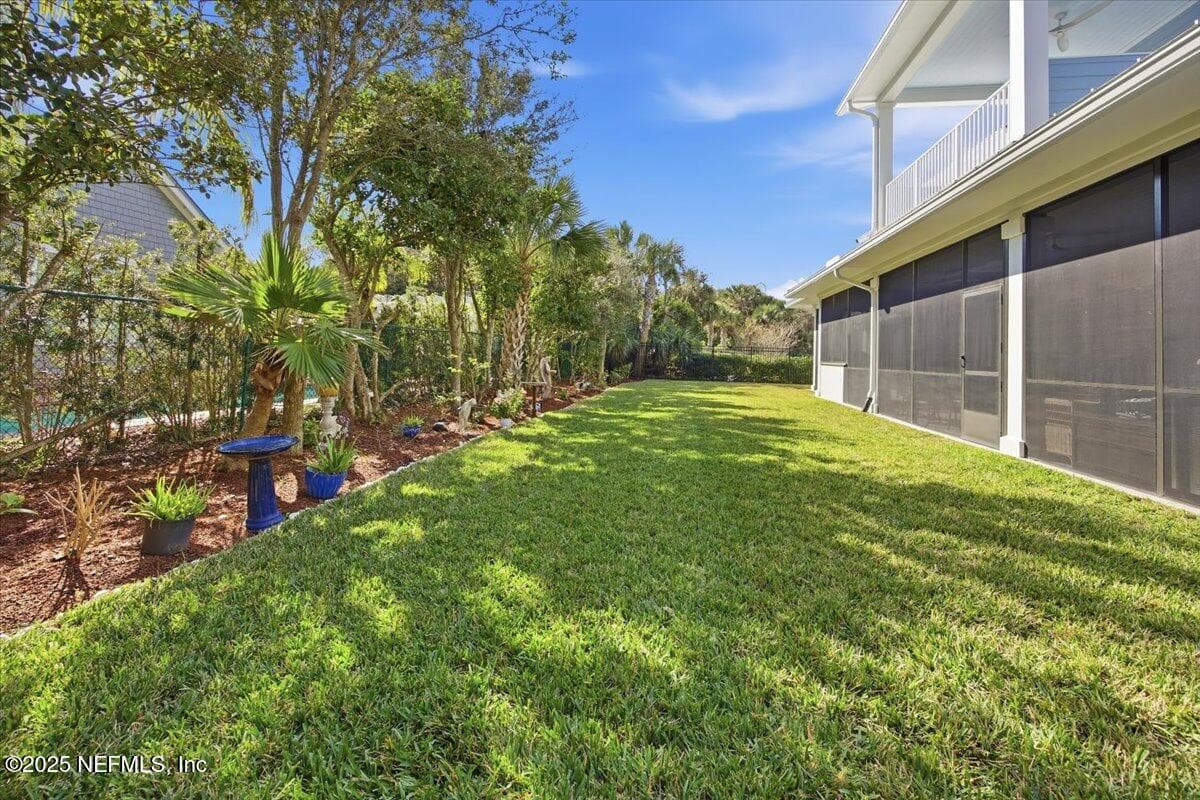 Sweet landscaping back here, and trees for privacy. The fence has small black wire, so kitty does not get out. Back yard has two fence gates from the front yard. — 4 SUMMER Court, Jacksonville Beach, FL 32250