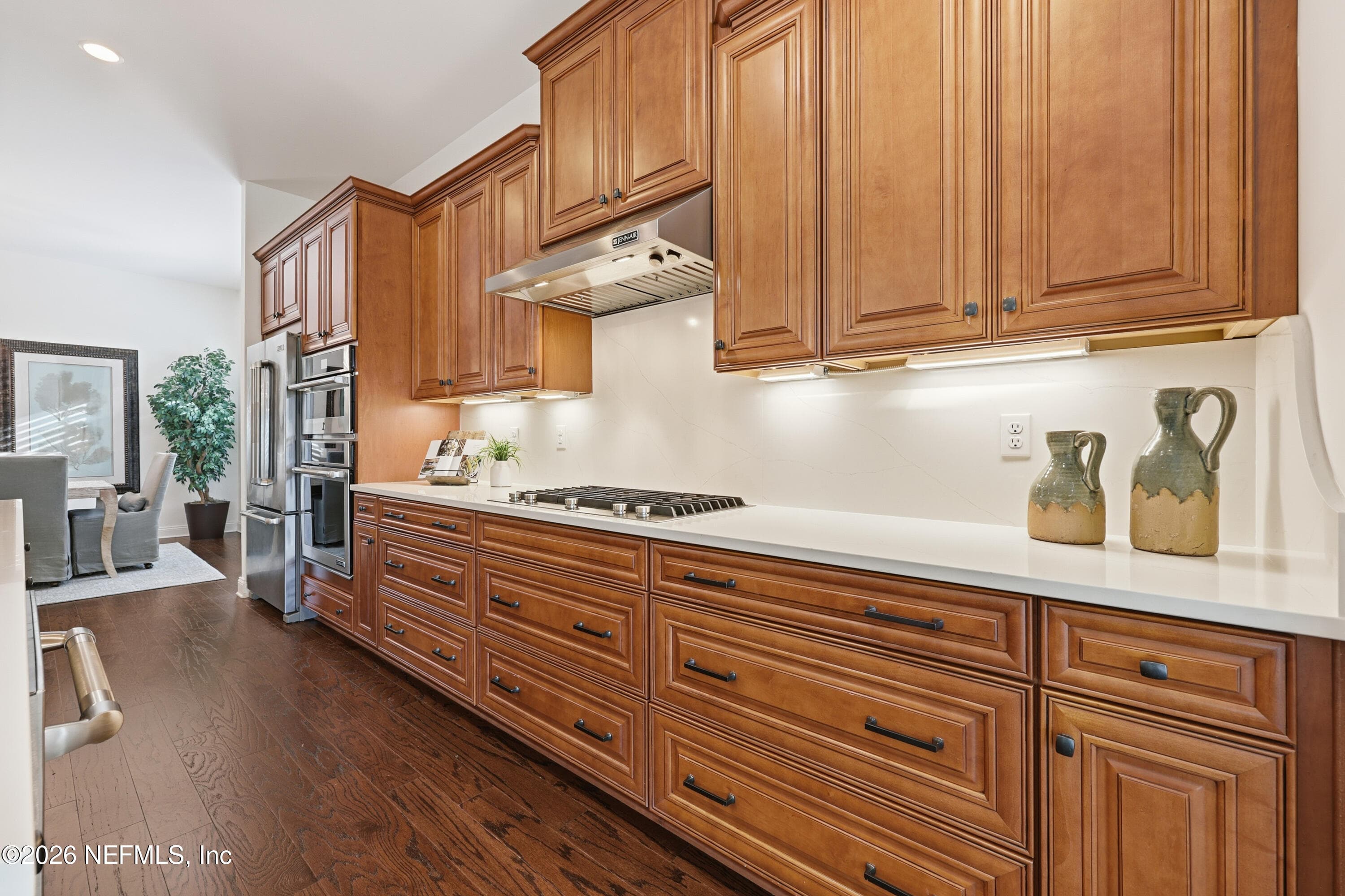 Kitchen wall with extensive wood cabinetry and long countertop workspace. — 568 TIMBER BRIDGE Lane, Atlantic Beach, FL 32233
