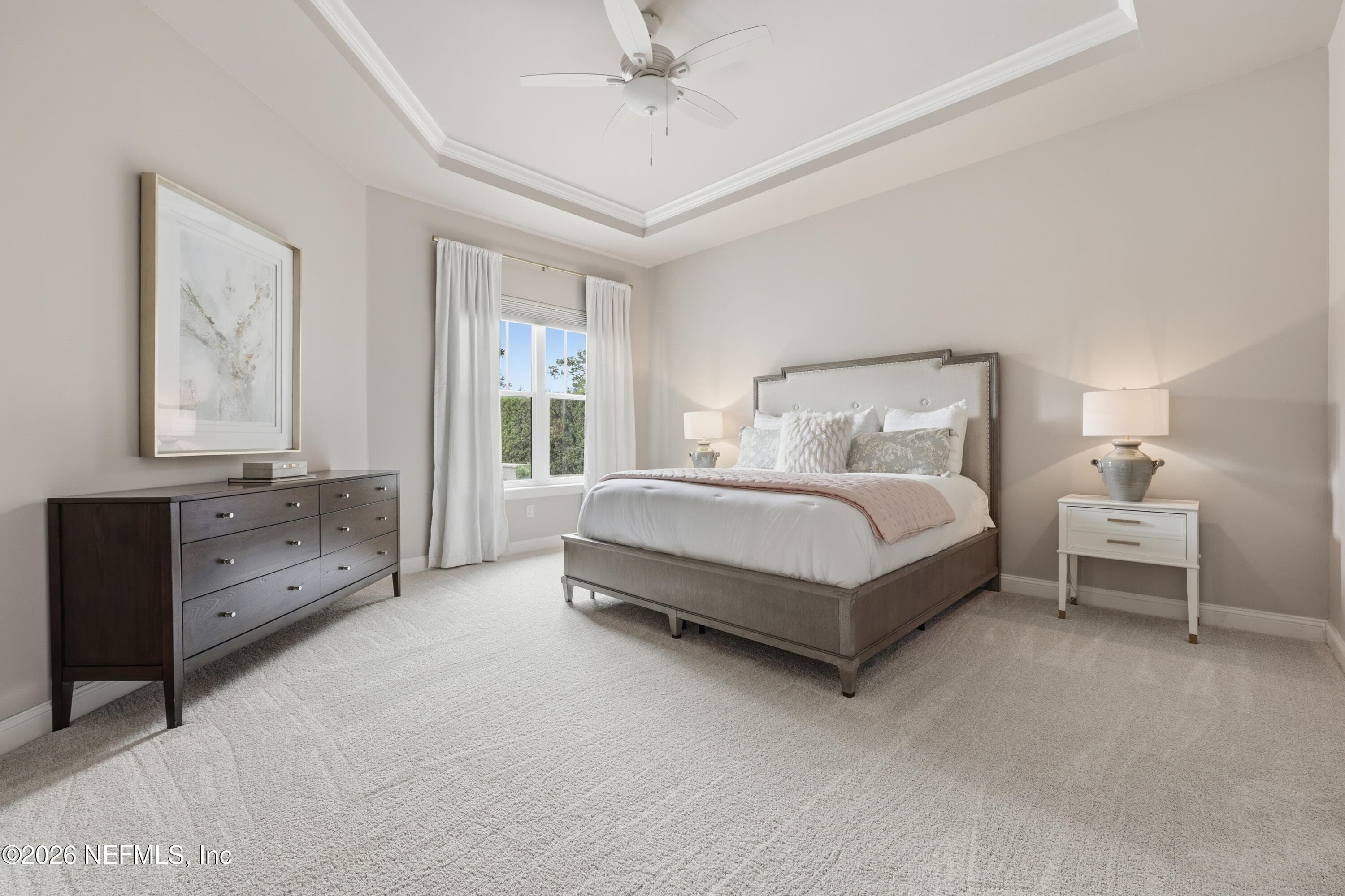 Primary bedroom with tray ceiling, ceiling fan, and neutral finishes. — 568 TIMBER BRIDGE Lane, Atlantic Beach, FL 32233