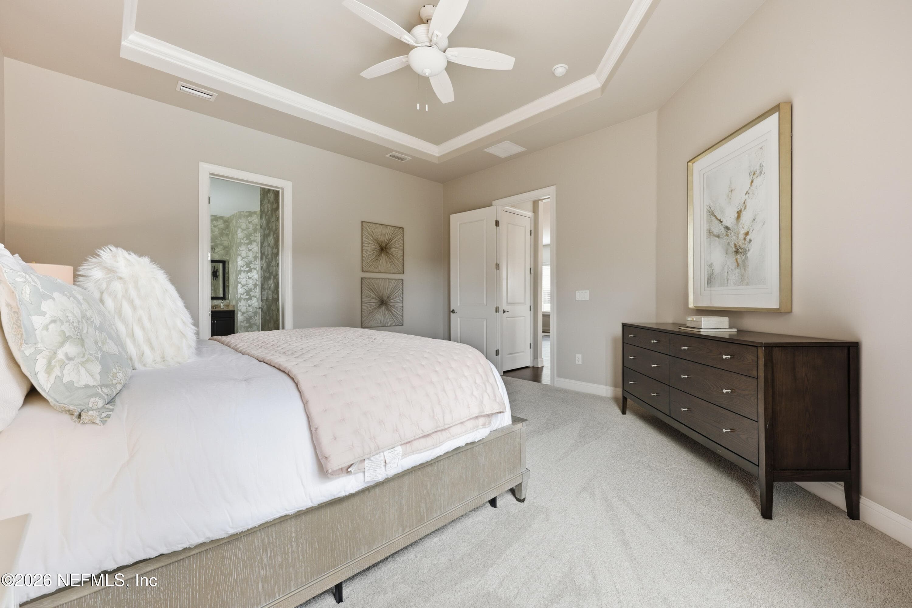 Primary bedroom with tray ceiling and ample wall space for varied furniture layouts. — 568 TIMBER BRIDGE Lane, Atlantic Beach, FL 32233