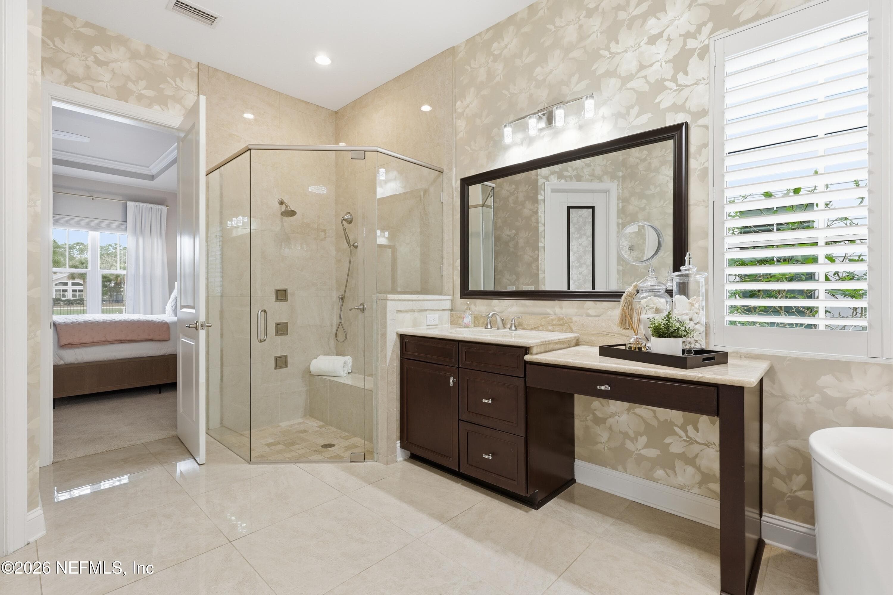 Primary bath showing glass shower, vanity cabinetry, and freestanding tub area. — 568 TIMBER BRIDGE Lane, Atlantic Beach, FL 32233