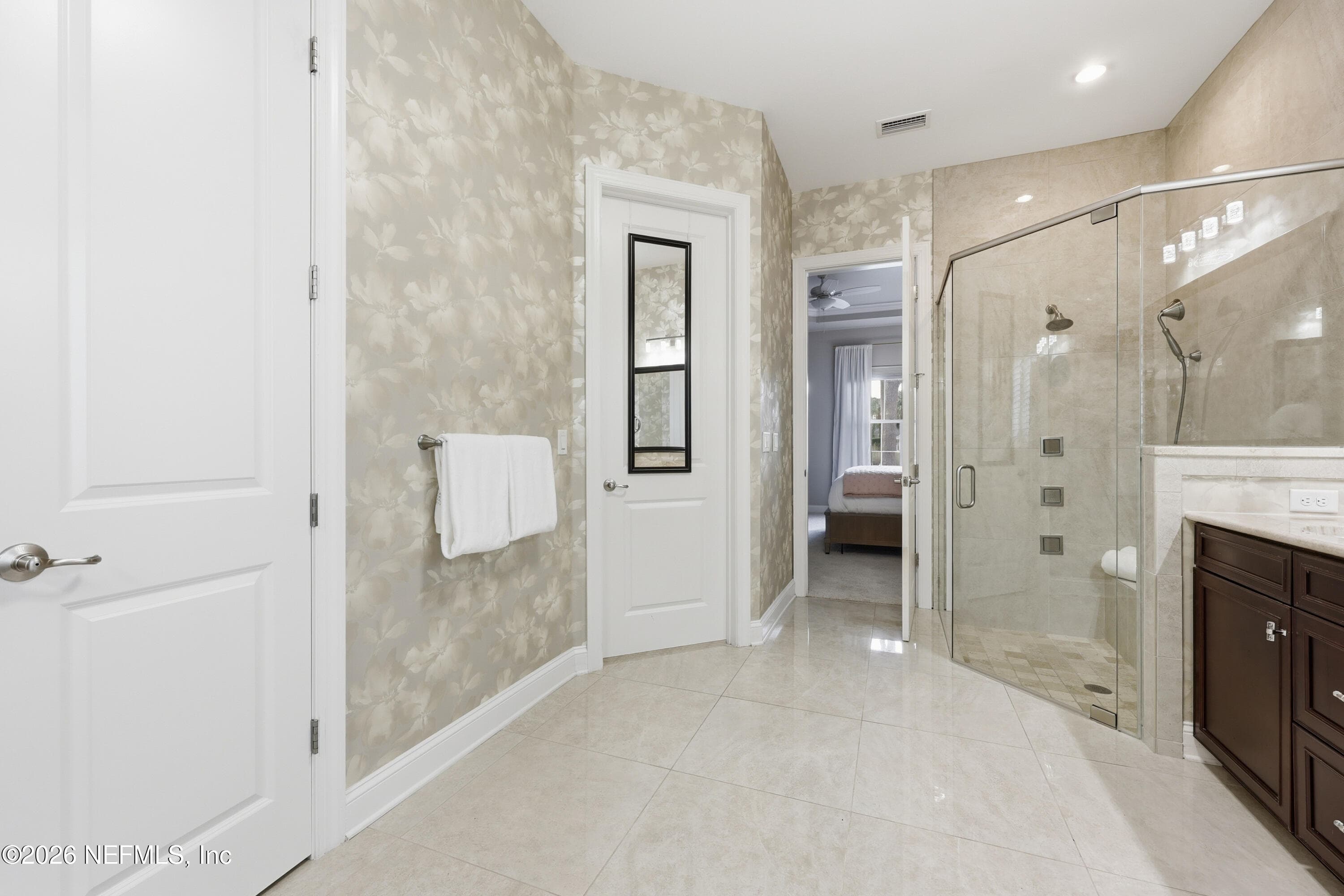 Primary bath layout with vanity, shower entry, and bright neutral finishes. — 568 TIMBER BRIDGE Lane, Atlantic Beach, FL 32233