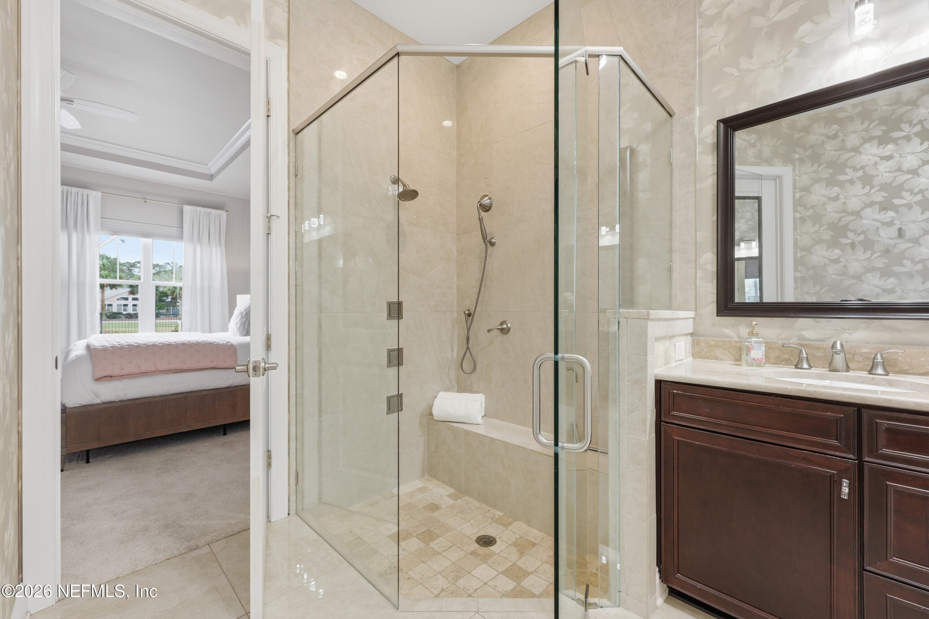 Glass-enclosed shower next to vanity with tile finishes in the primary bath. — 568 TIMBER BRIDGE Lane, Atlantic Beach, FL 32233
