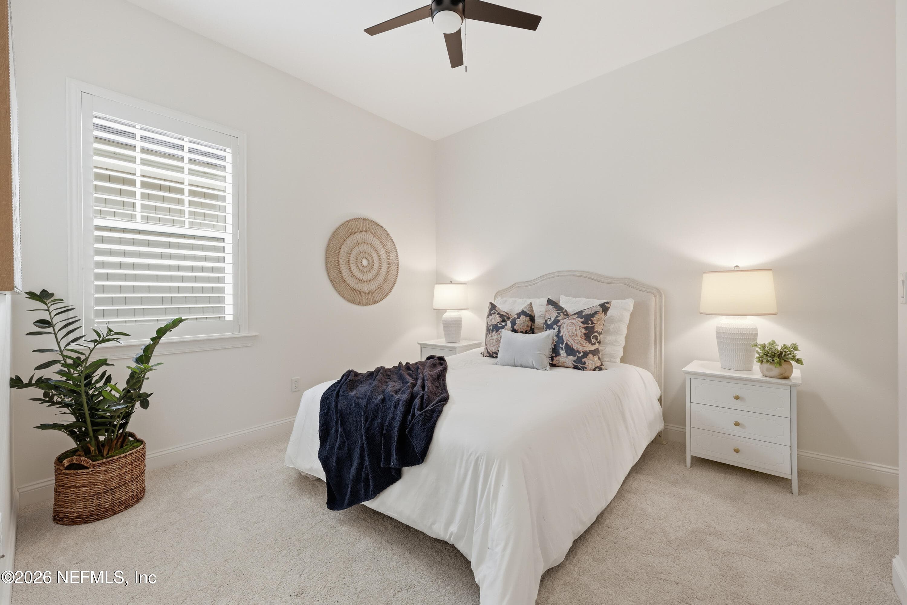 First-floor bedroom with ceiling fan and neutral carpet flooring. — 568 TIMBER BRIDGE Lane, Atlantic Beach, FL 32233