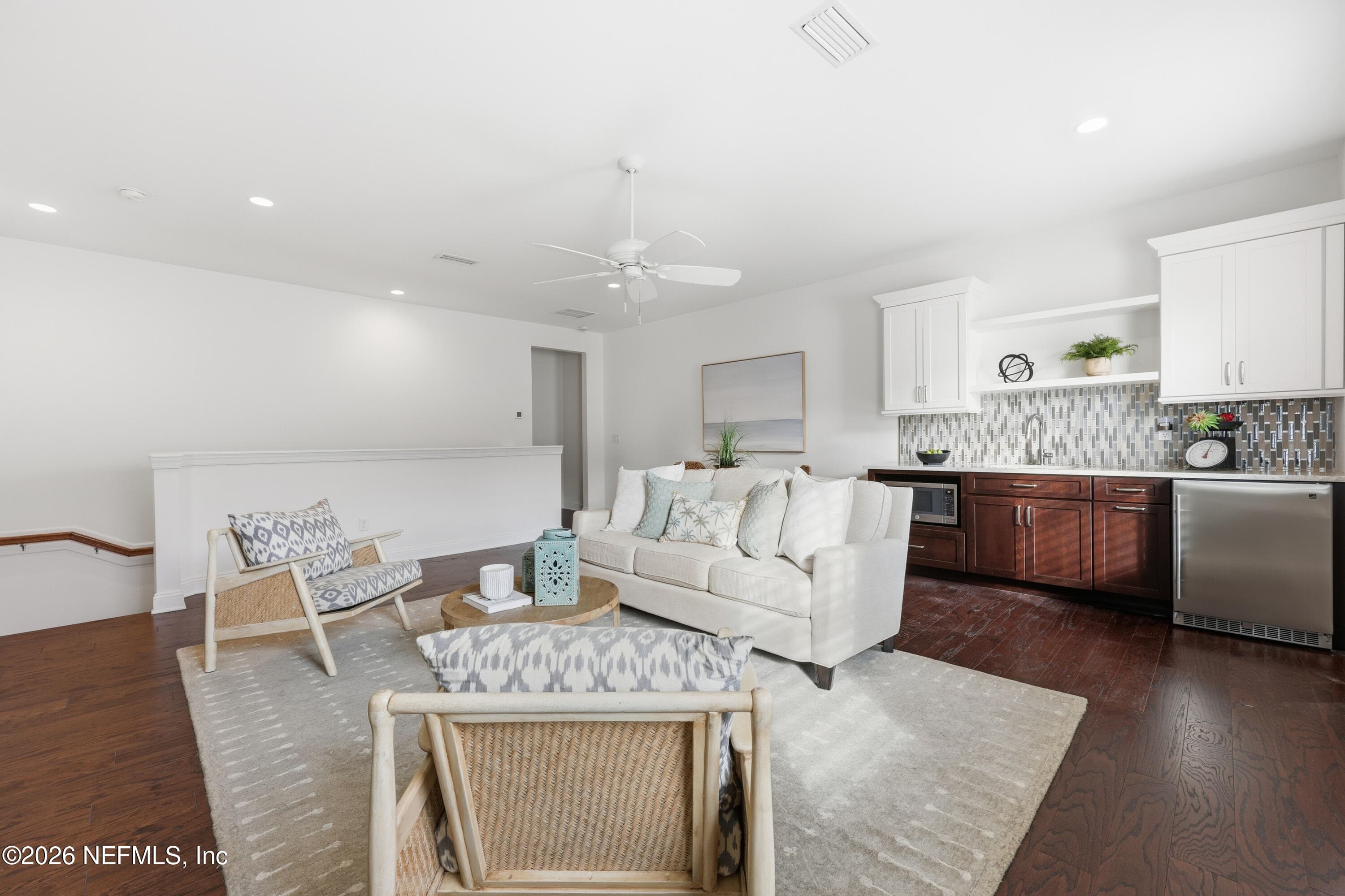 Open great room connecting living and kitchen with continuous hardwood flooring. — 568 TIMBER BRIDGE Lane, Atlantic Beach, FL 32233