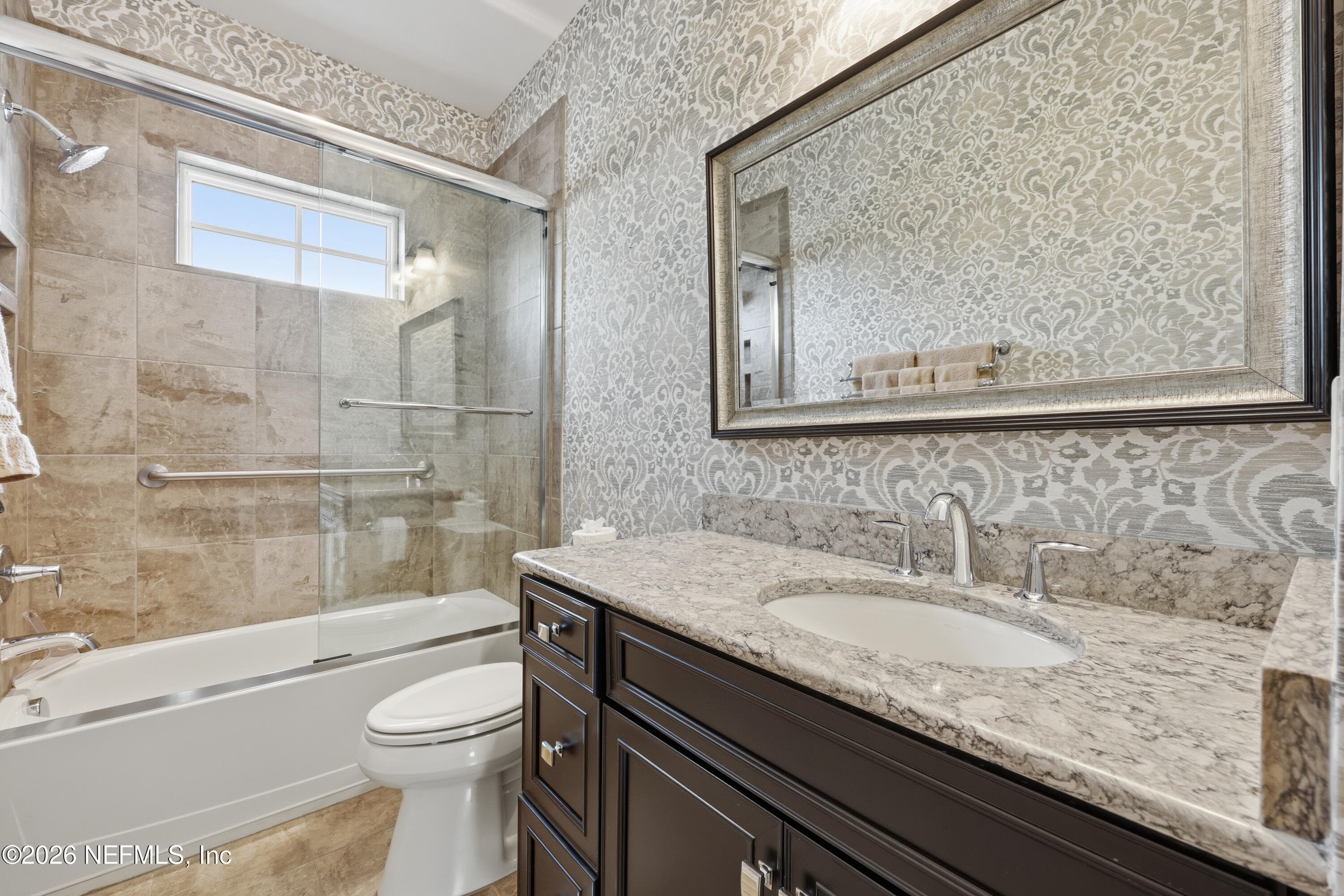 First-floor guest bathroom with vanity and tile surround with glass enclosure. — 568 TIMBER BRIDGE Lane, Atlantic Beach, FL 32233