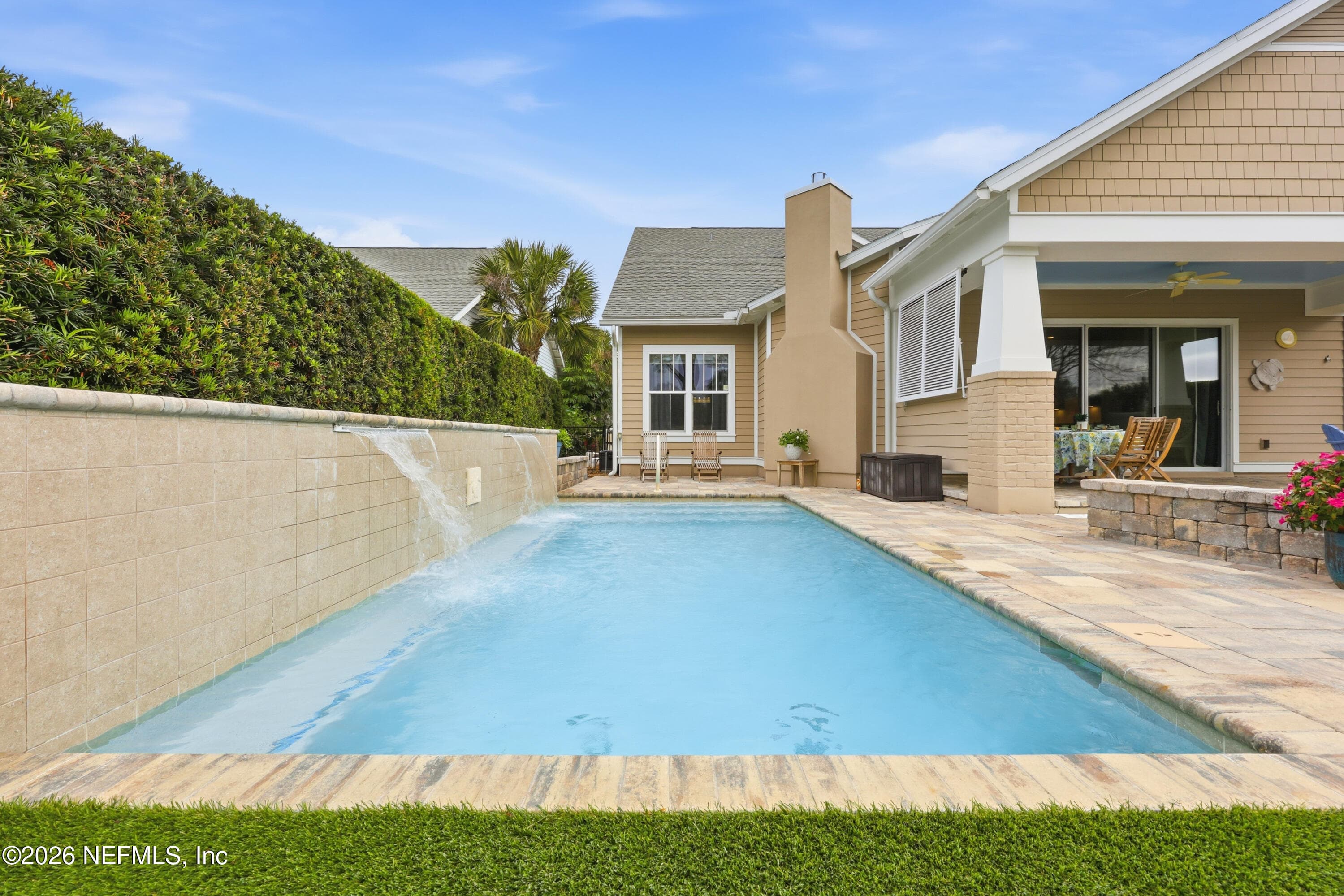 Pool area with paver deck adjacent to the home’s covered outdoor living space. — 568 TIMBER BRIDGE Lane, Atlantic Beach, FL 32233