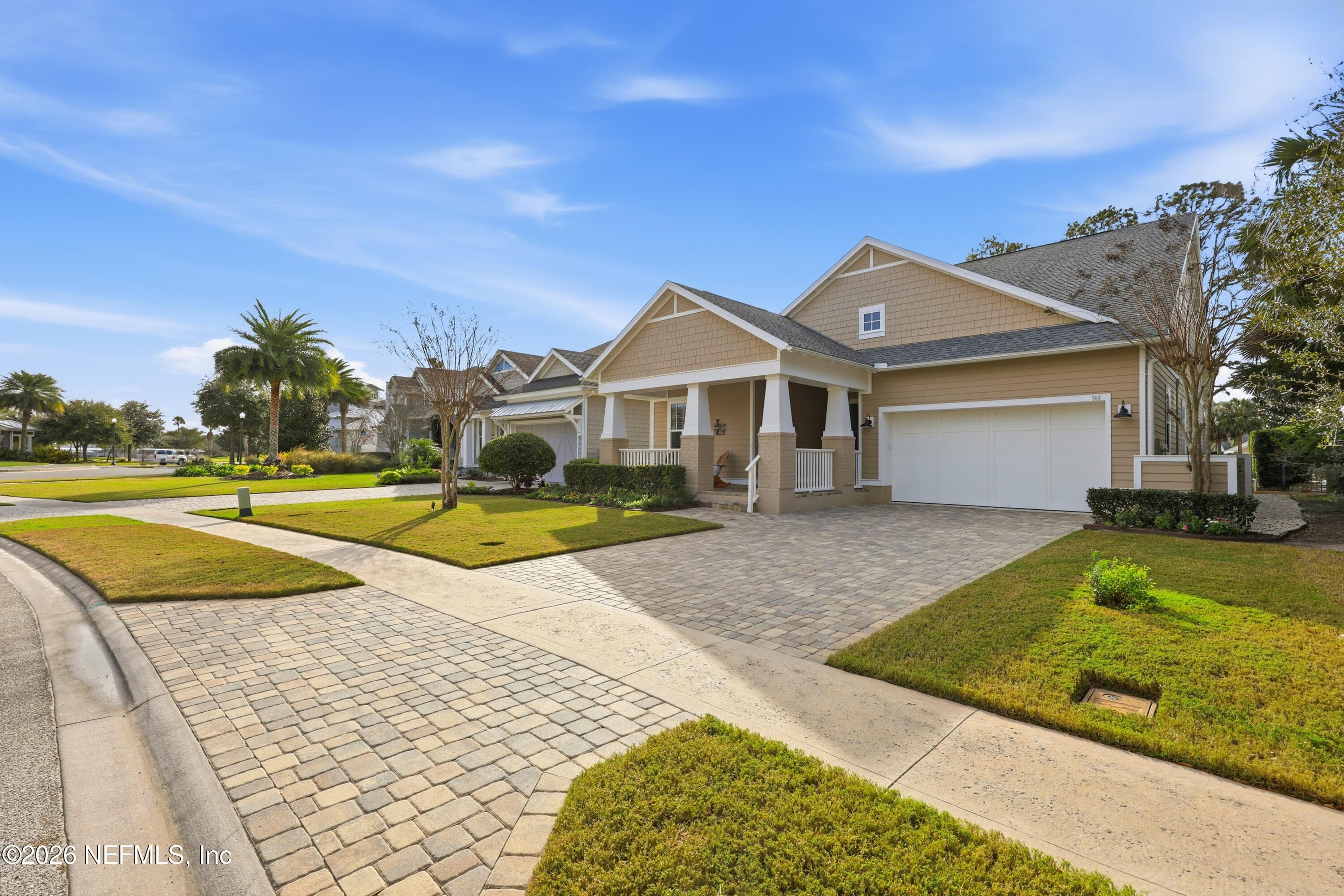 Craftsman-style home with paver driveway and attached two-car garage. — 568 TIMBER BRIDGE Lane, Atlantic Beach, FL 32233