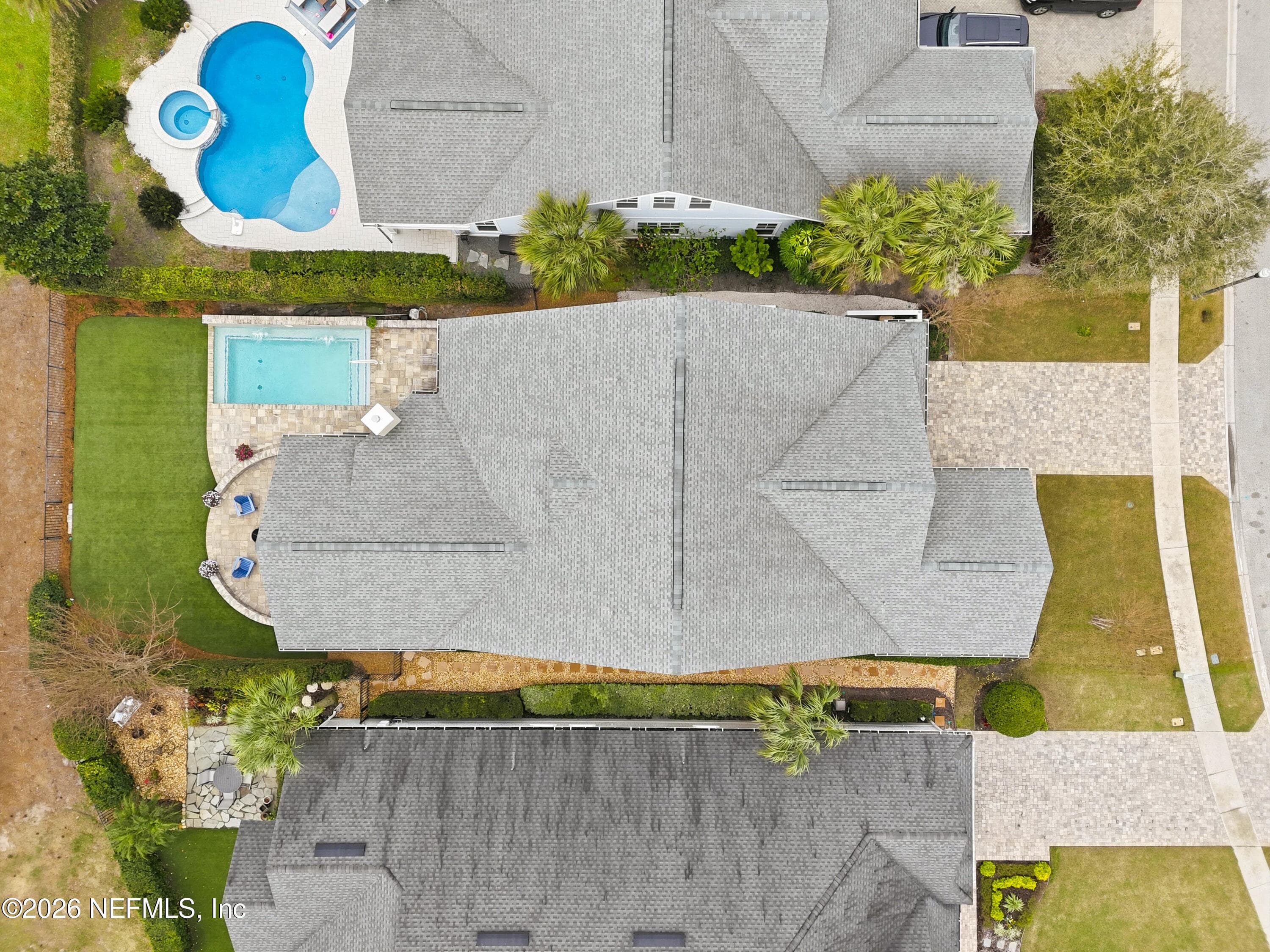 Top-down aerial showing roofline and pool placement within the lot. — 568 TIMBER BRIDGE Lane, Atlantic Beach, FL 32233