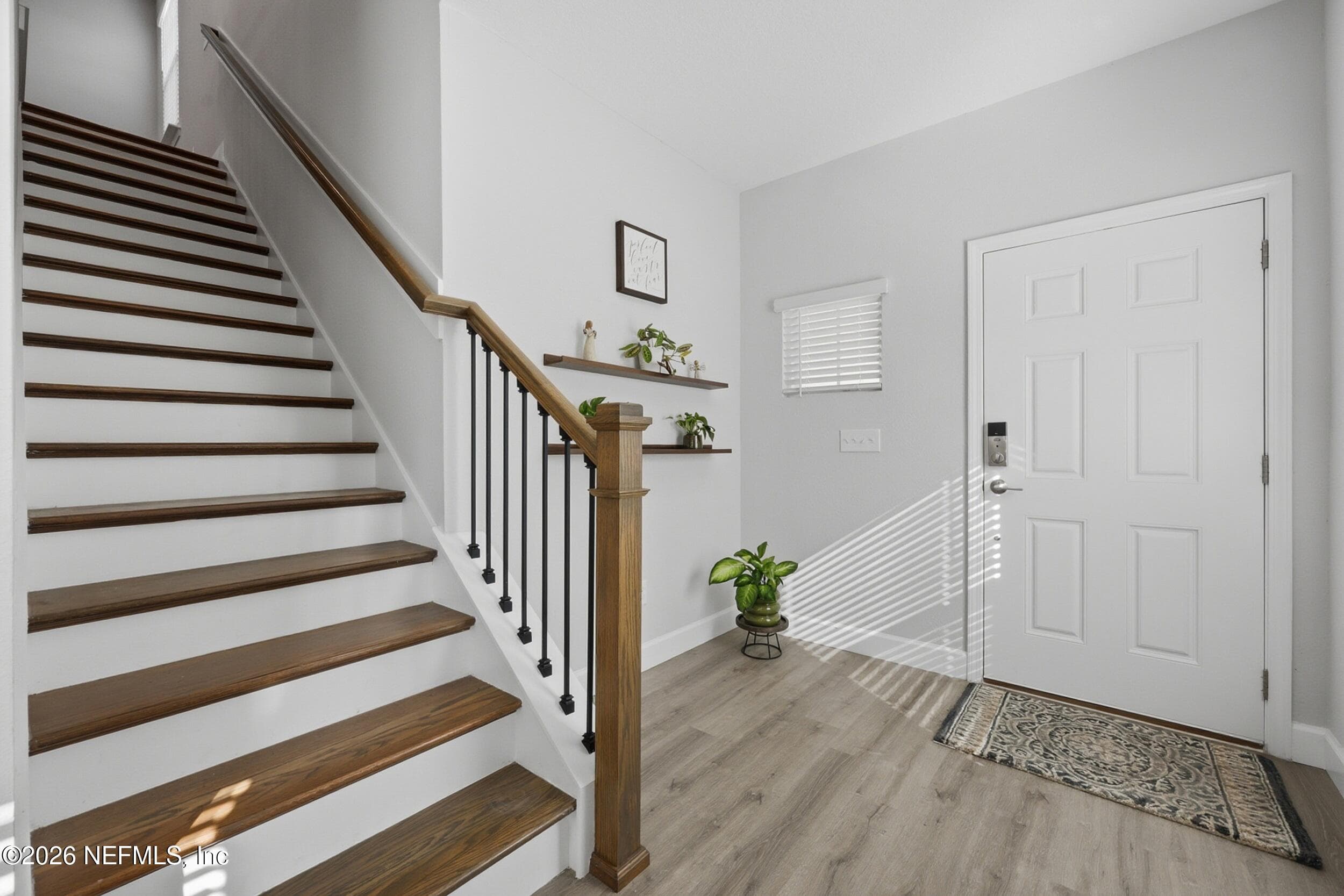 Luxury vinyl plank thoughout common areas on main floor and on stairs leading to upper level — 95252 TERRIS Way, Fernandina Beach, FL 32034