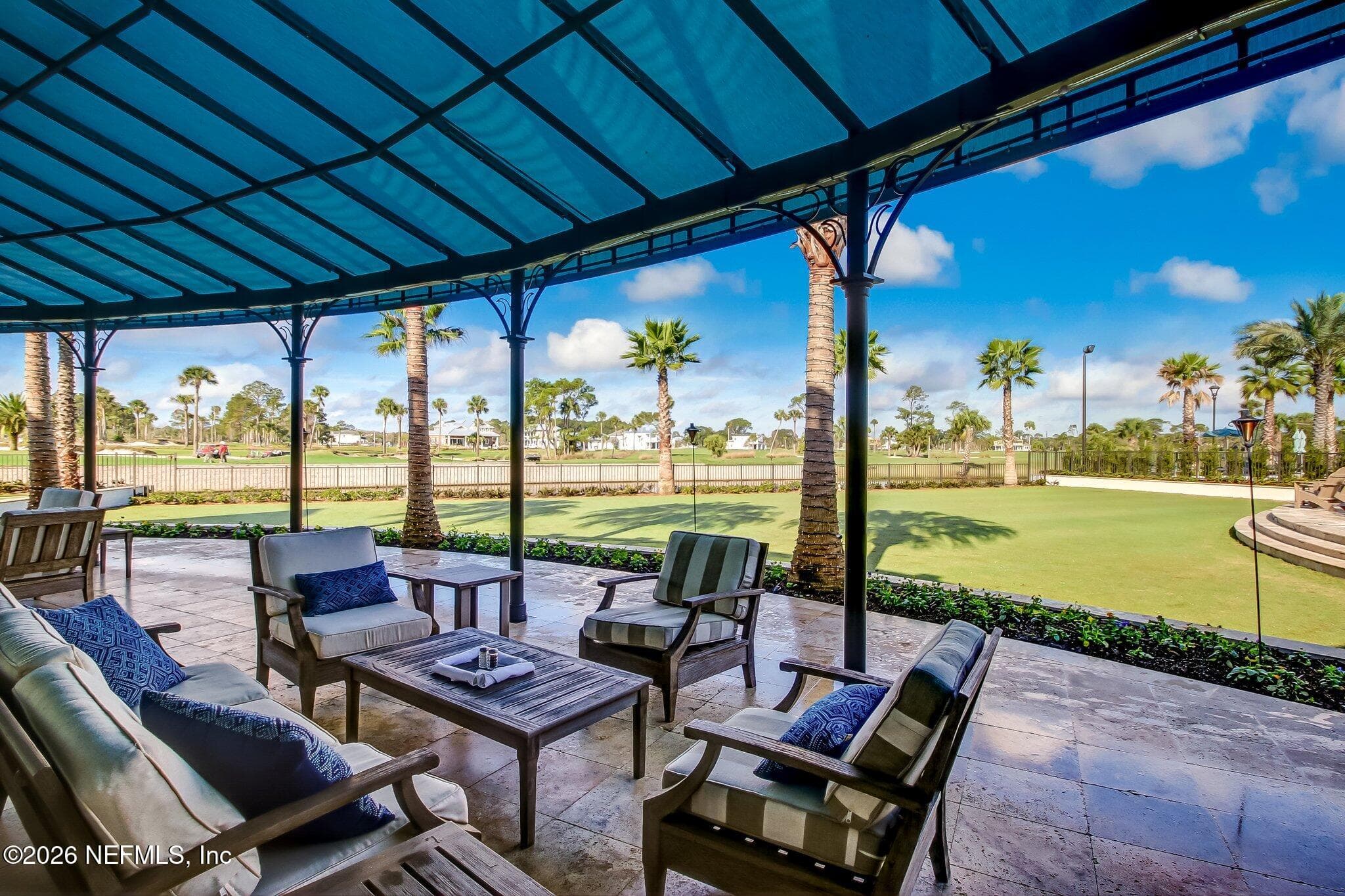 Covered outdoor seating area at the club overlooking golf-course greens. — 568 TIMBER BRIDGE Lane, Atlantic Beach, FL 32233