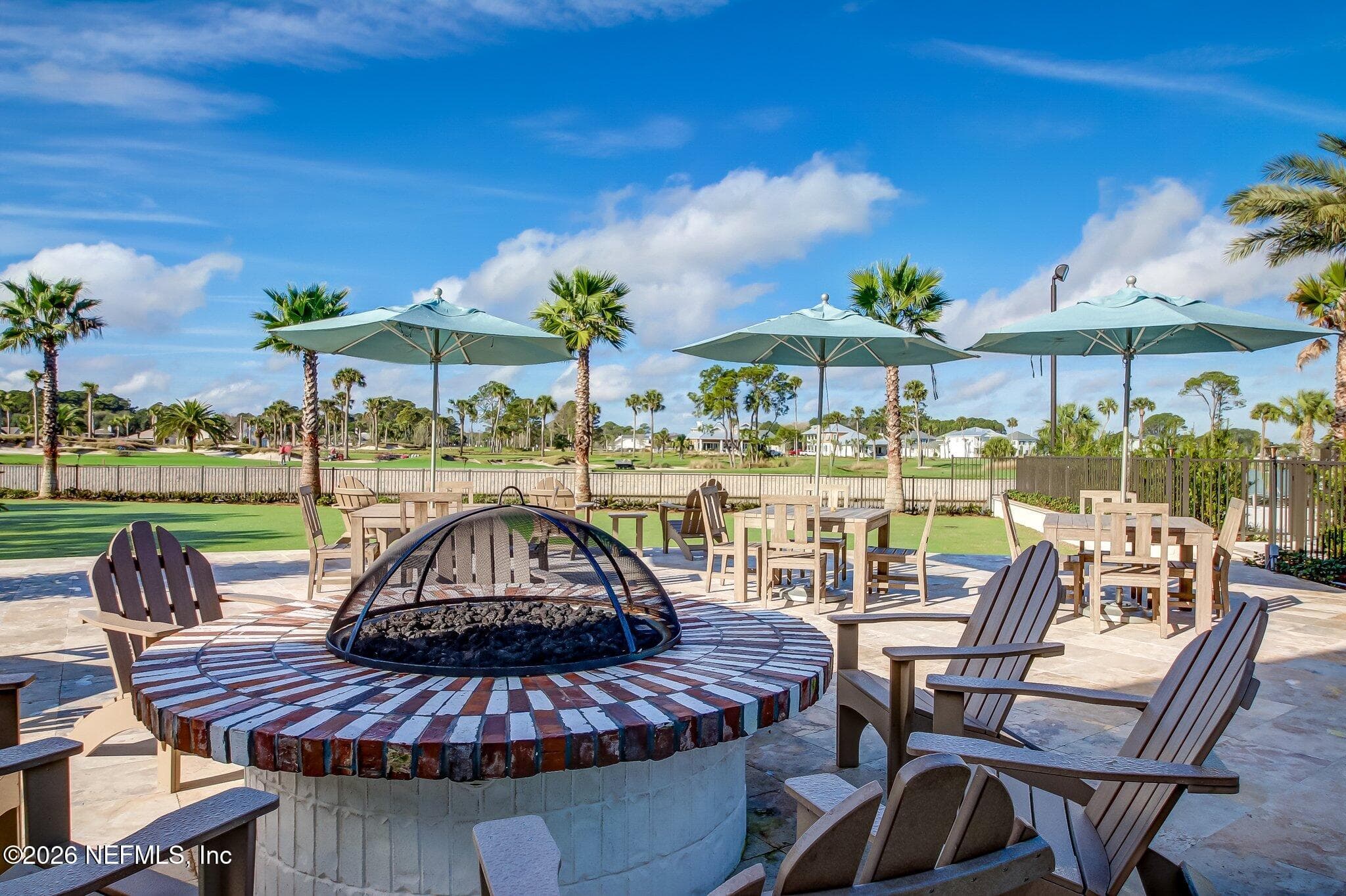 Community outdoor firepit area with seating and umbrellas near amenities. — 568 TIMBER BRIDGE Lane, Atlantic Beach, FL 32233