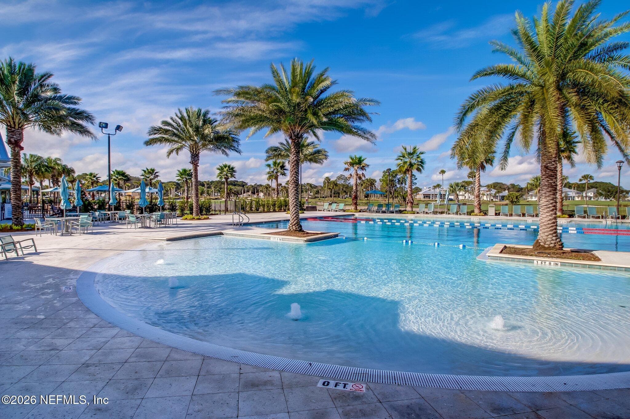 Community pool with expansive deck and palm landscaping. — 568 TIMBER BRIDGE Lane, Atlantic Beach, FL 32233