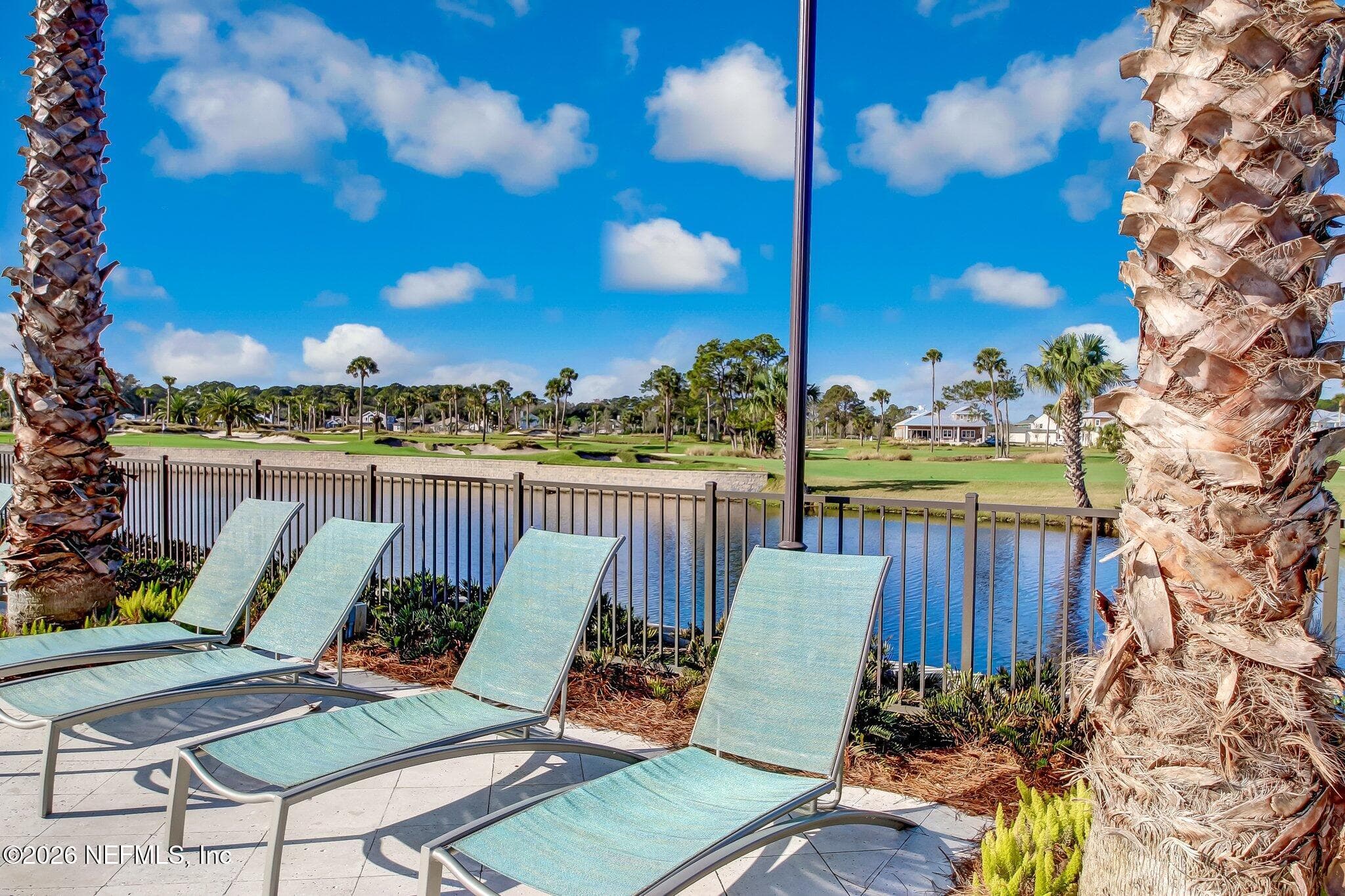 Poolside chaise lounges overlooking community water/greens. — 568 TIMBER BRIDGE Lane, Atlantic Beach, FL 32233