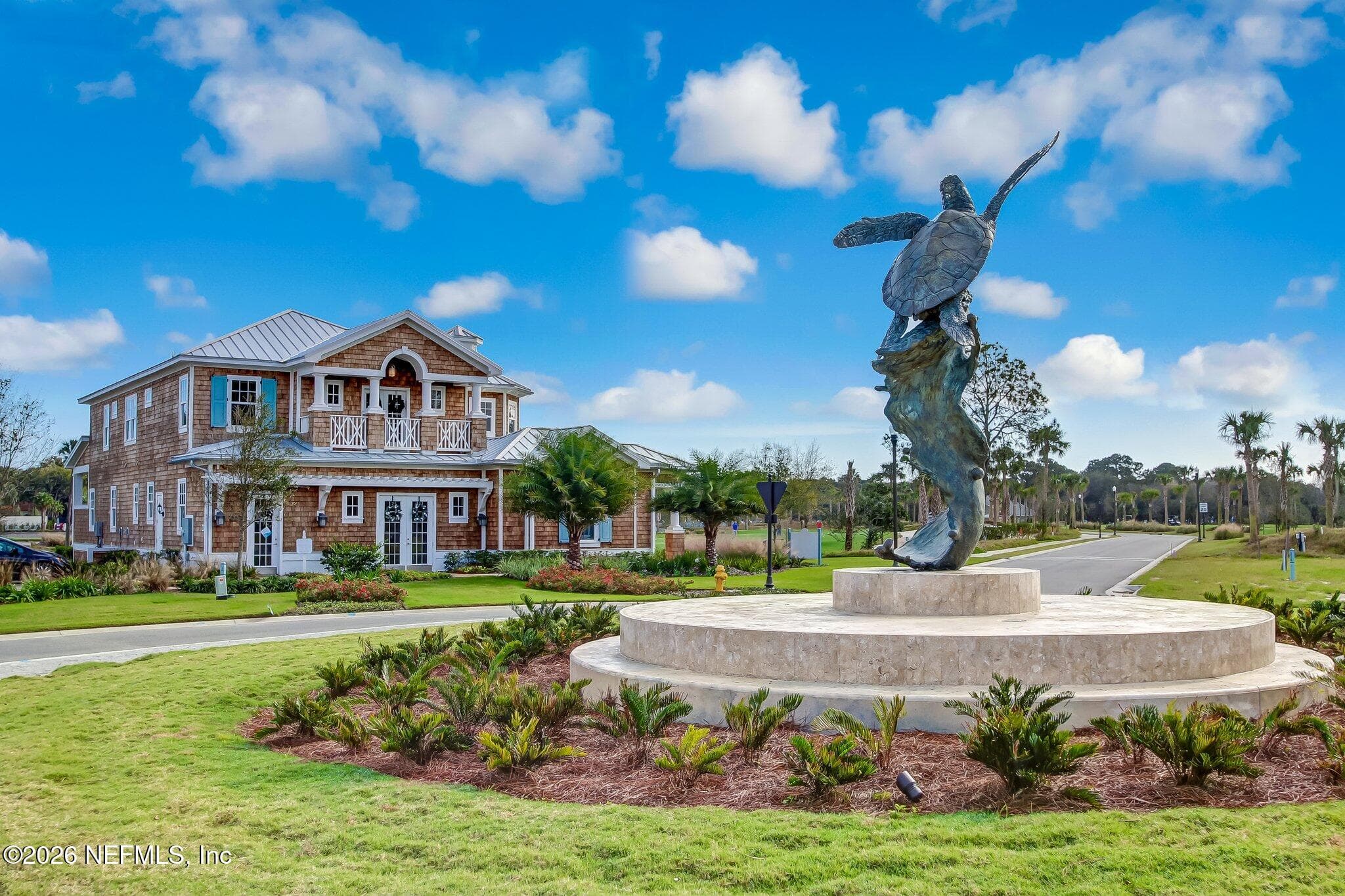 Community roundabout with landscaped monument and neighborhood streetscape. — 568 TIMBER BRIDGE Lane, Atlantic Beach, FL 32233