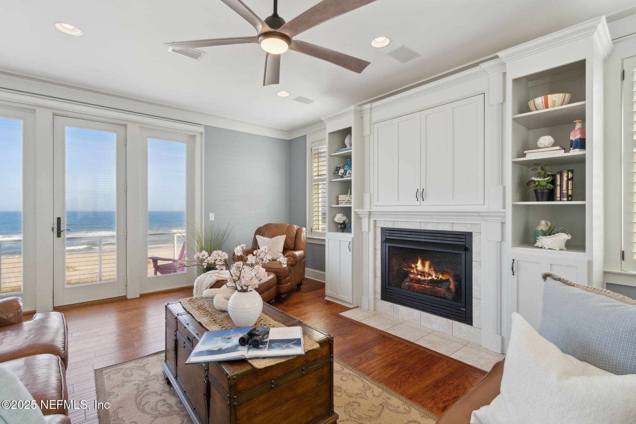Elegant details abound, with custom millwork, cherry-hued wood flooring, plantation shutters, and a cozy gas fireplace creating a refined yet inviting ambiance. — 822 S FLETCHER Avenue, Fernandina Beach, FL 32034