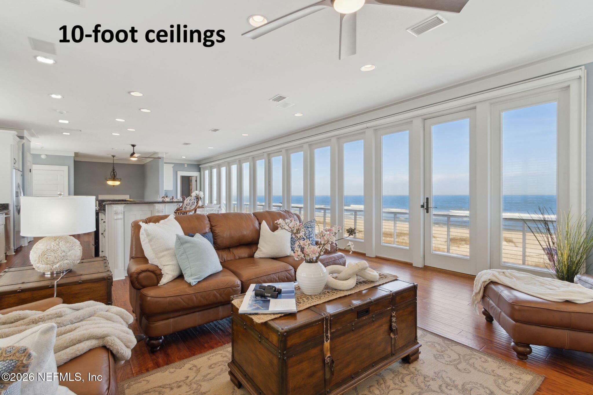 The main living area on the third floor showcases a breathtaking wall of floor-to-ceiling glass doors ... — 822 S FLETCHER Avenue, Fernandina Beach, FL 32034