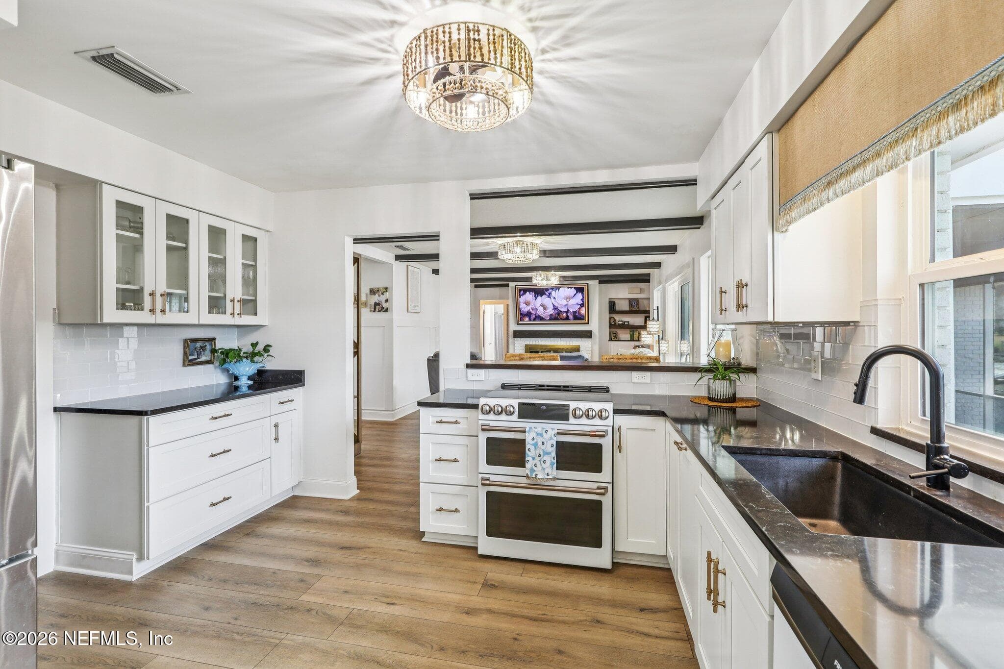 Kitchen with black counters, subway tile and lake views — 244 JESSIE LEE Court, Green Cove Springs, FL 32043