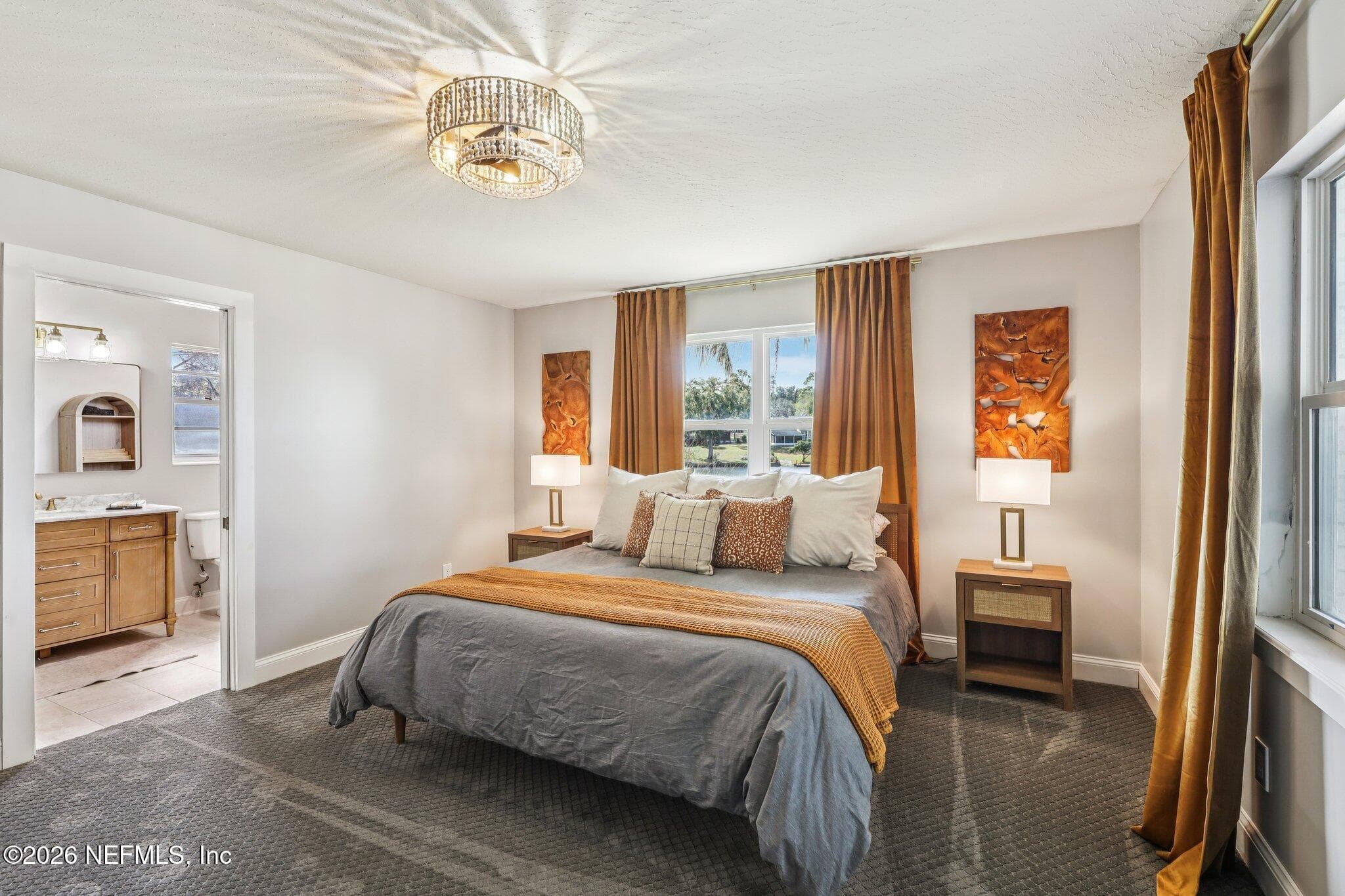 Primary bedroom with modern lighting and warm finishes — 244 JESSIE LEE Court, Green Cove Springs, FL 32043