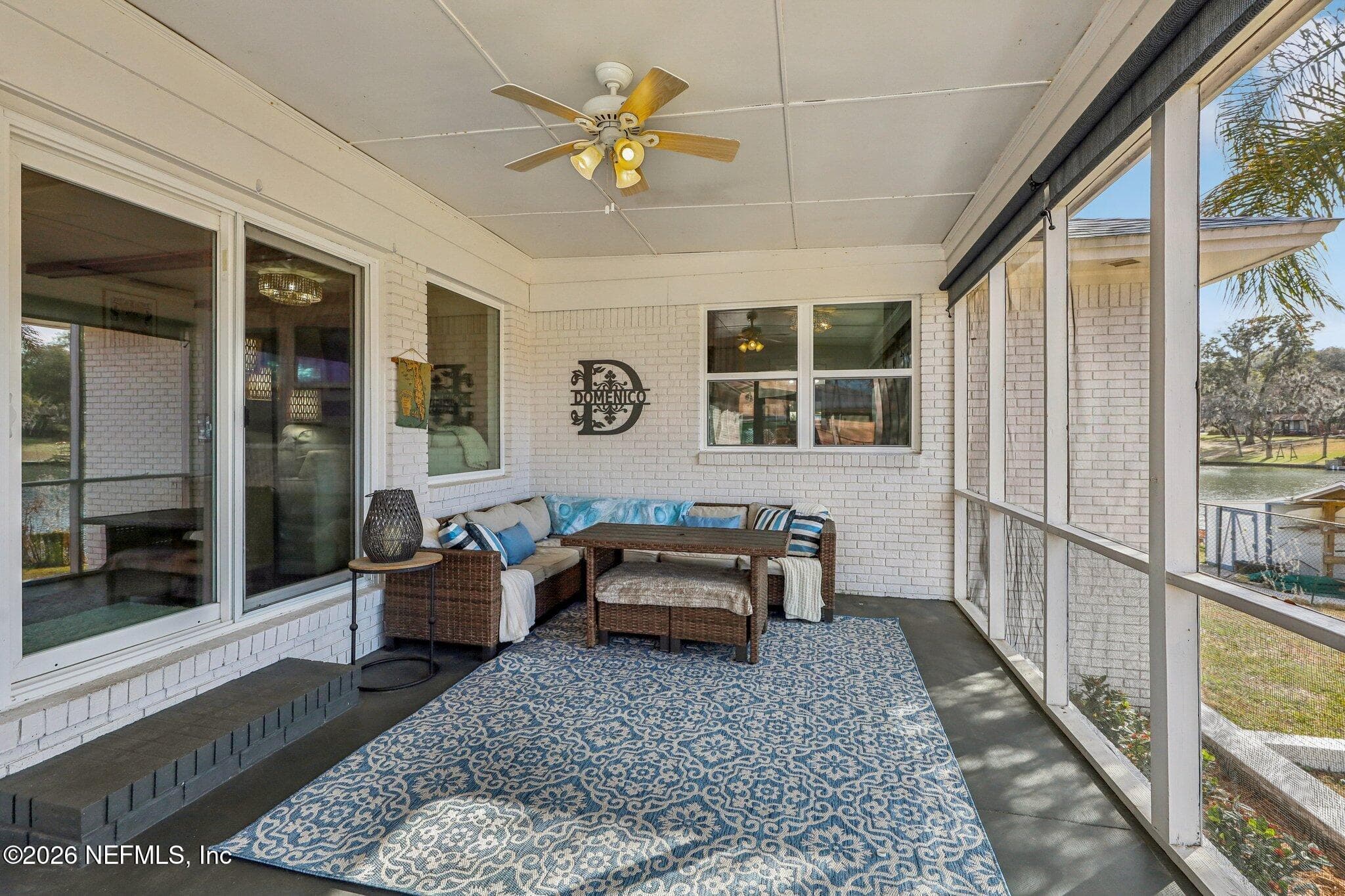 Screened porch with comfortable seating and lake views — 244 JESSIE LEE Court, Green Cove Springs, FL 32043
