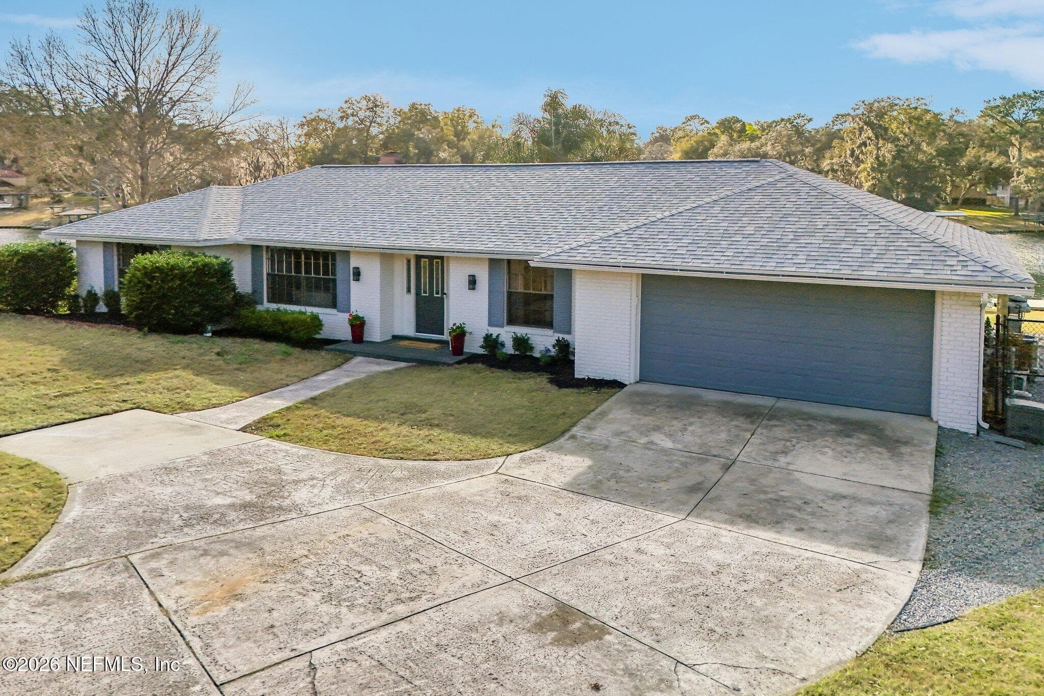Beautiful front exterior with wide driveway and welcoming entry — 244 JESSIE LEE Court, Green Cove Springs, FL 32043