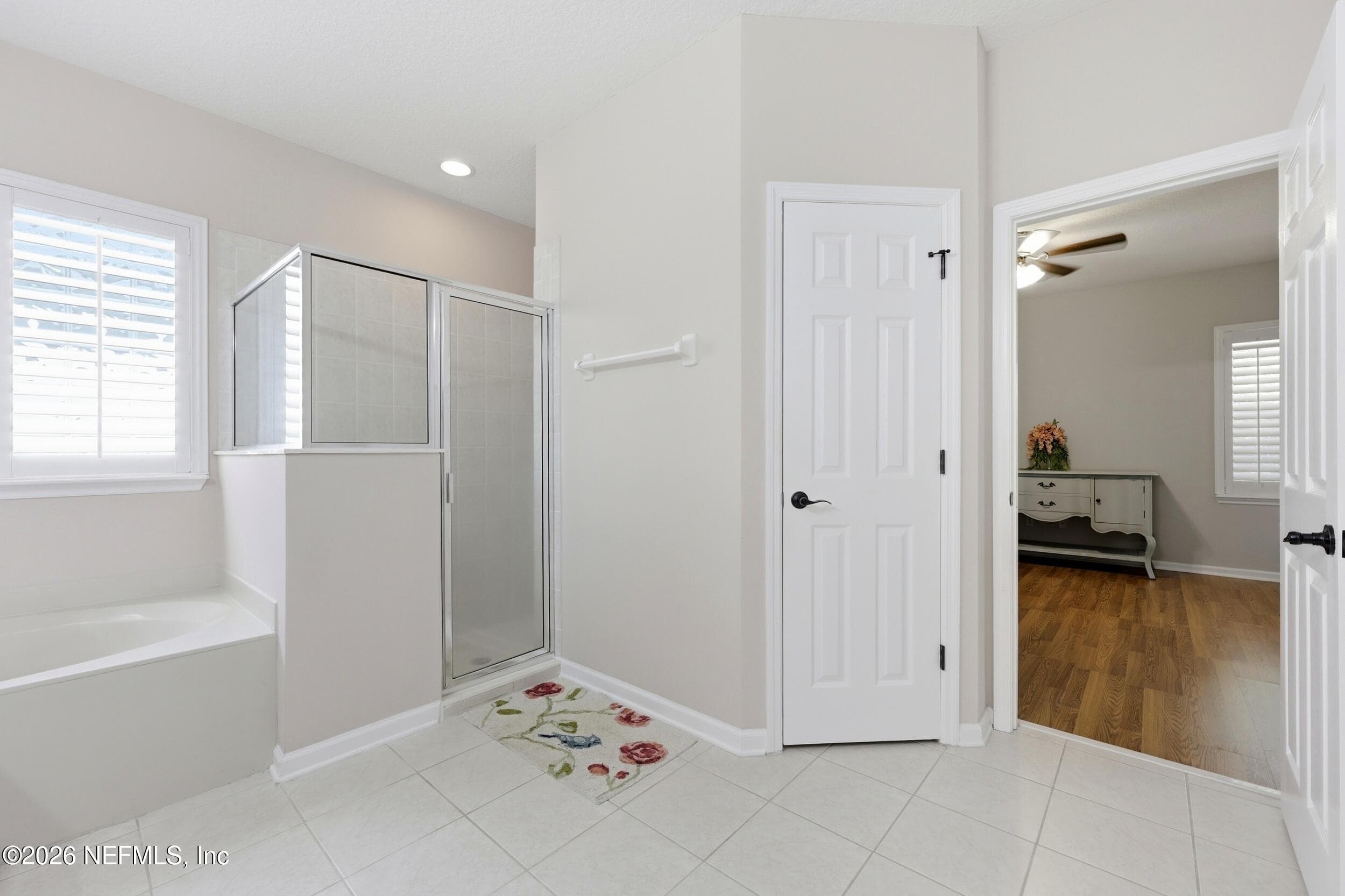 Tub to the left + walk-in shower. Double Doors lead to the bedroom — 96177 LONG BEACH Drive, Fernandina Beach, FL 32034