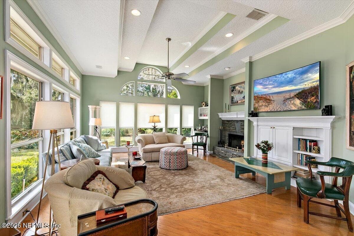 Large family room with wood burning fireplace; expansive views of lagoon and golf course — 117 MEETING Way, Ponte Vedra Beach, FL 32082