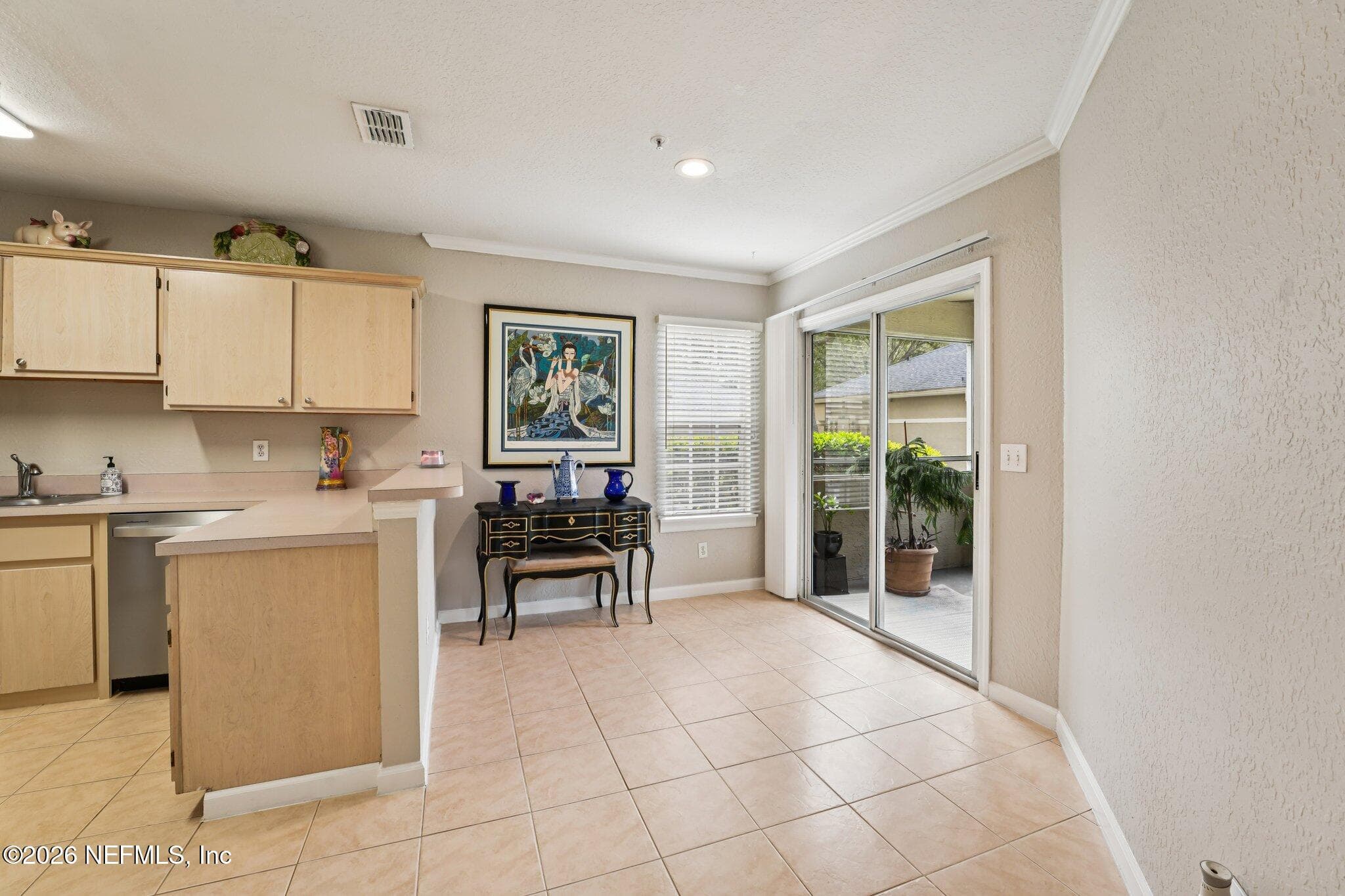 Dining room view of the screened in patio — 1701 THE GREENS Way 212, Jacksonville Beach, FL 32250