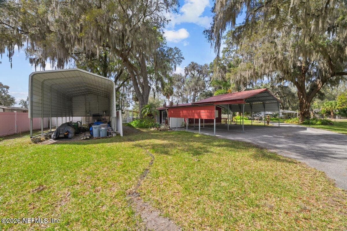 RV carport with hook up and 3 car carport — 101 ORANGE Street, Satsuma, FL 32189