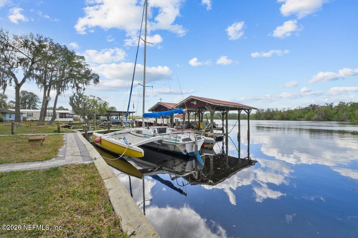 large Dock with 2 covered boat slip with electric lifts and jet ski lift — 101 ORANGE Street, Satsuma, FL 32189