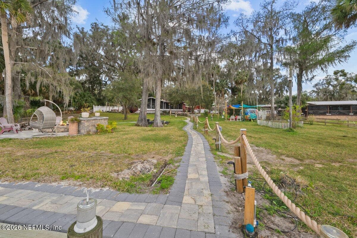 Pavers leading to home, dock and firepit area- Looking back towards Home — 101 ORANGE Street, Satsuma, FL 32189