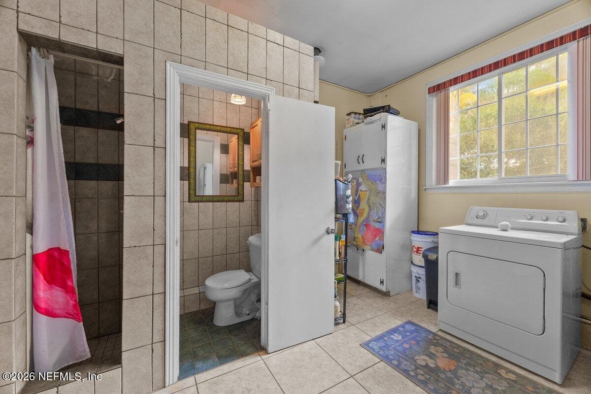 Laundry room off of kitchen with a shower and toilet — 101 ORANGE Street, Satsuma, FL 32189